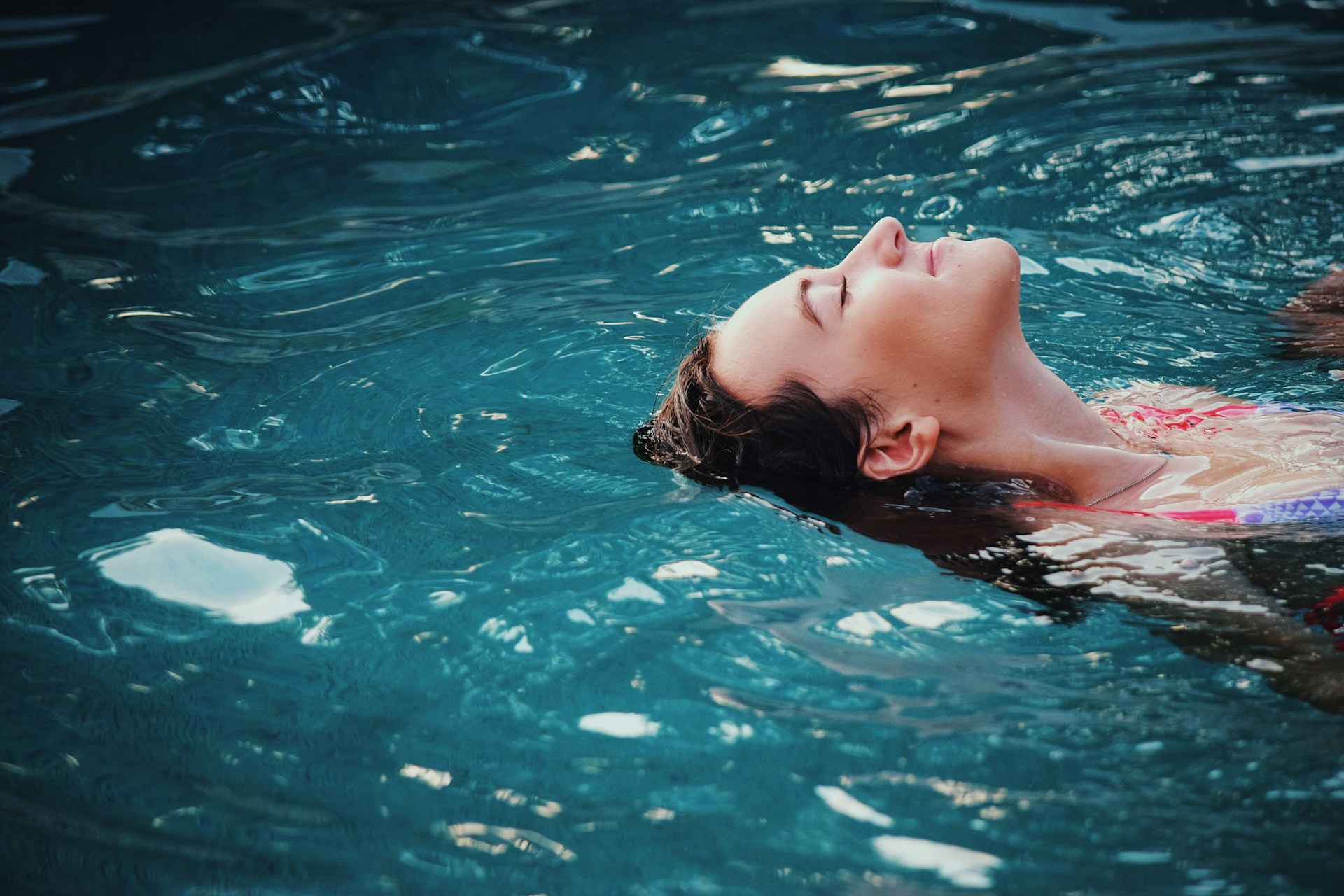 A person floating in a pool