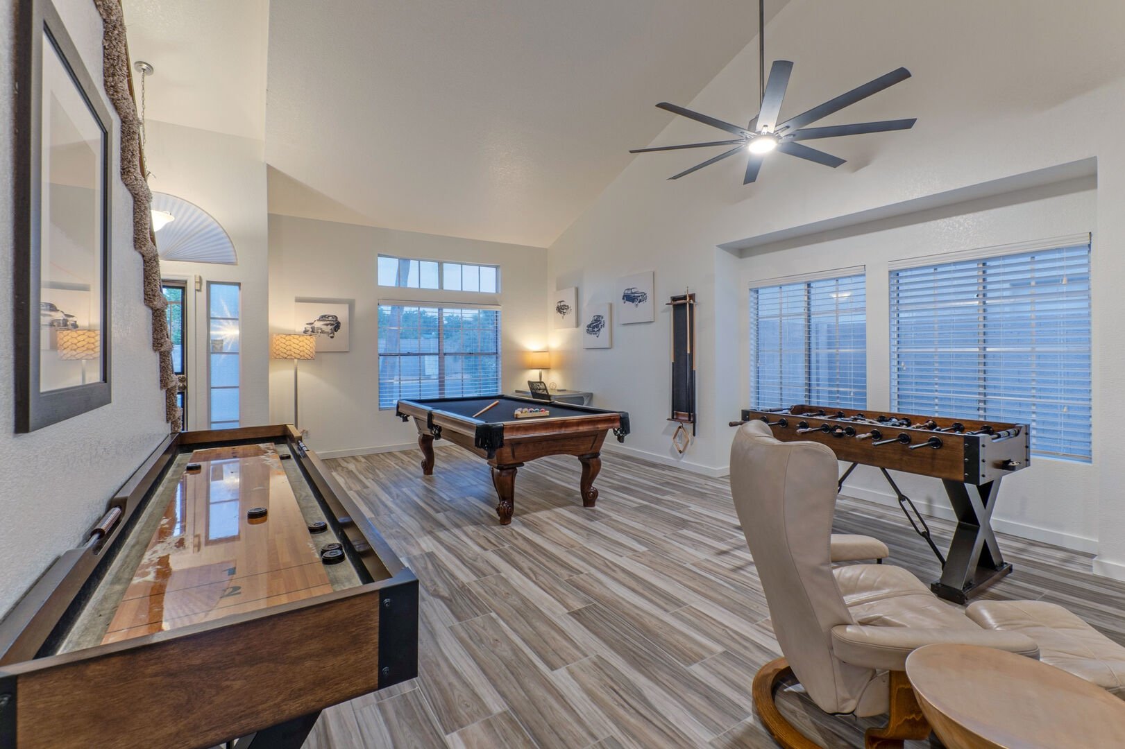 Game room with pool table, shuffleboard, and foosball