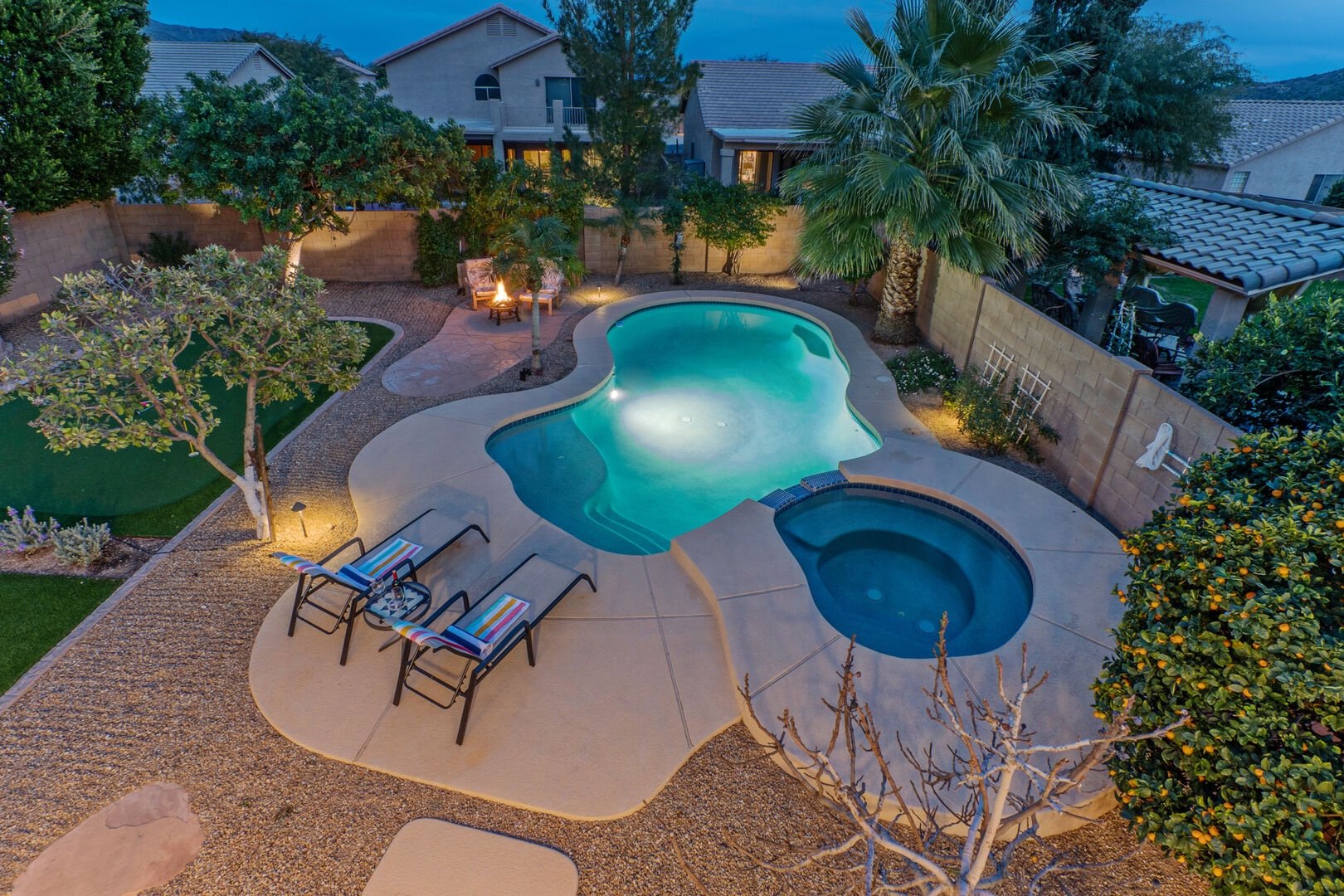 Aerial view of pool and backyard at dusk