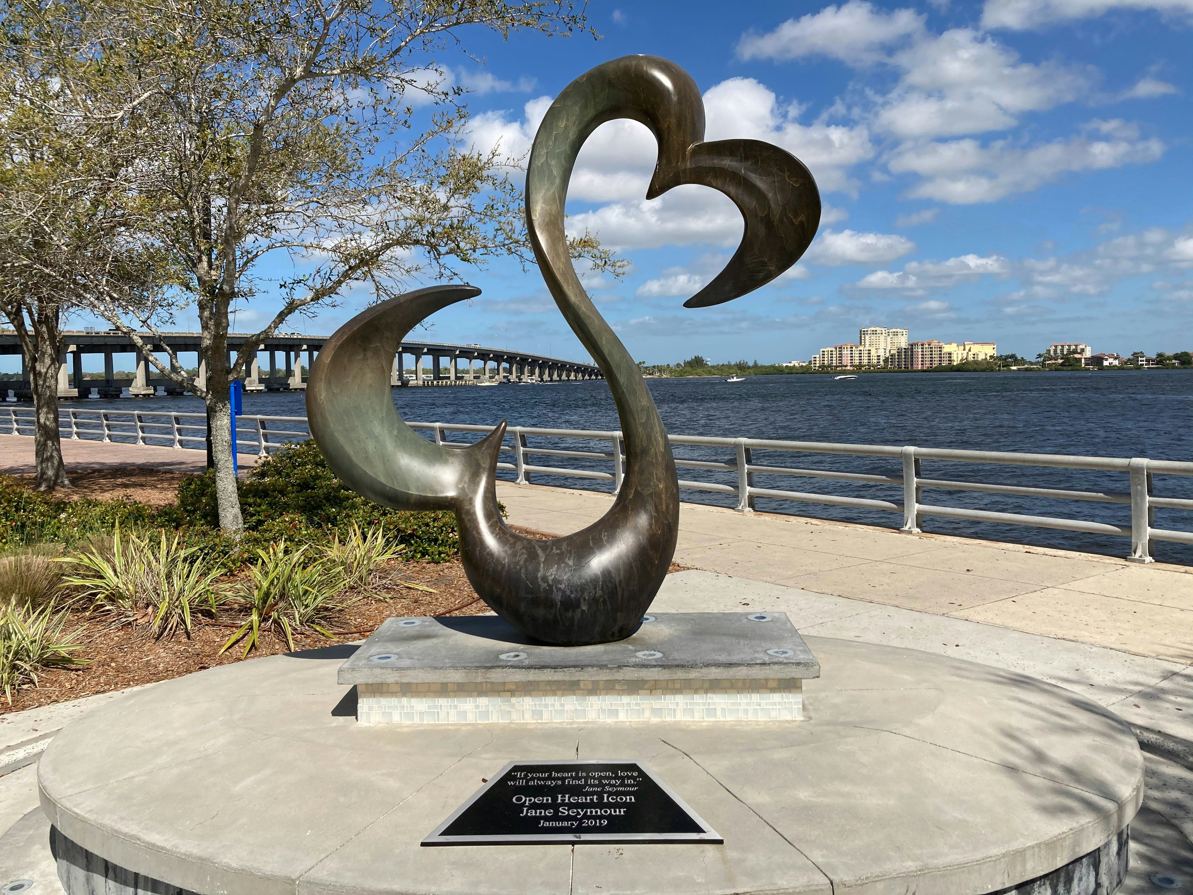 Bradenton Riverwalk sculpture with Manatee River and bridge, Bradenton, Florida