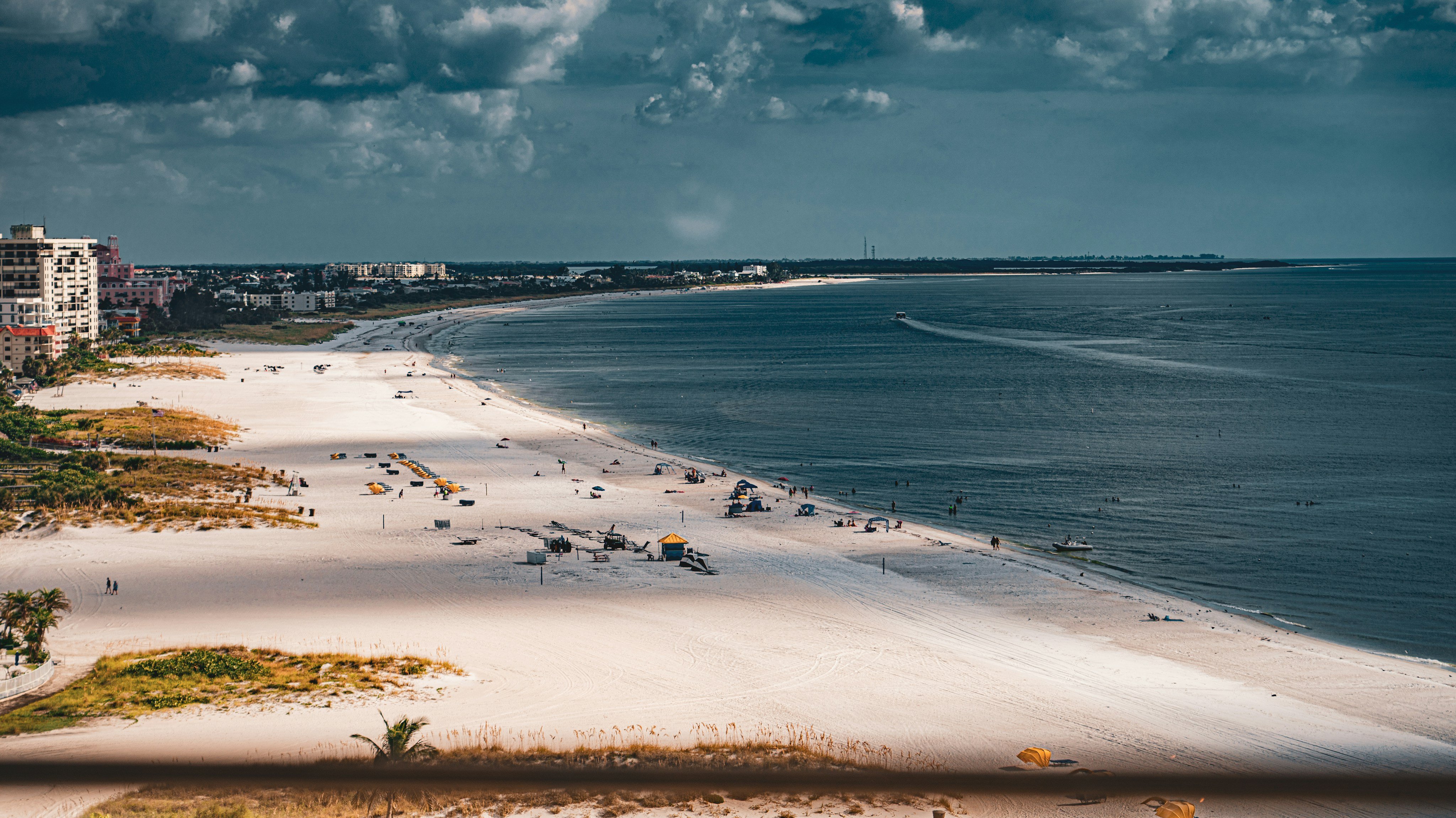 Wide white sand beach with coastal city in the background near Saint Petersburg, Florida