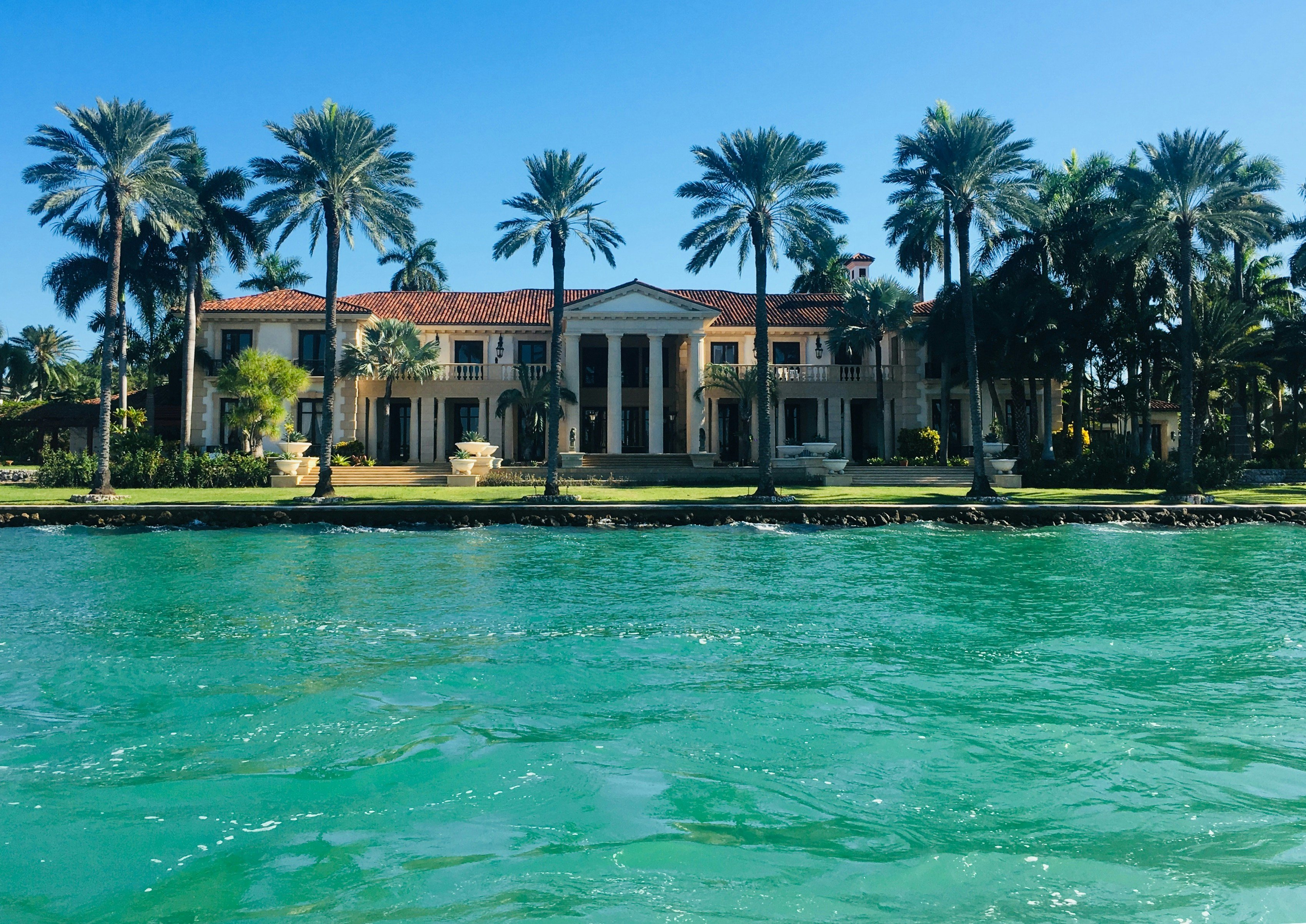 Grand waterfront estate with palm trees and turquoise water, Anna Maria Island, Florida