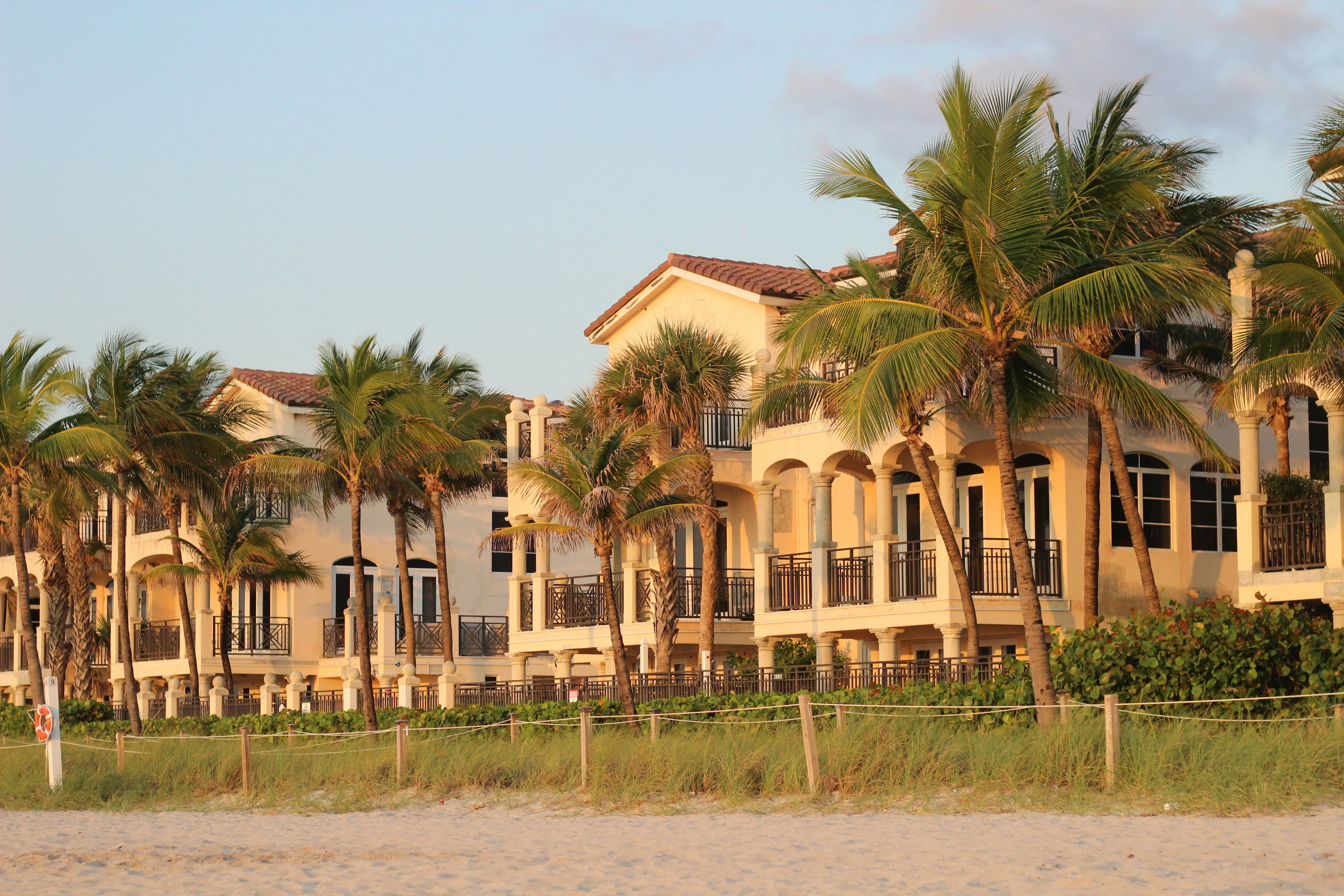 Mediterranean beachfront estate with palm trees on the Florida Gulf Coast