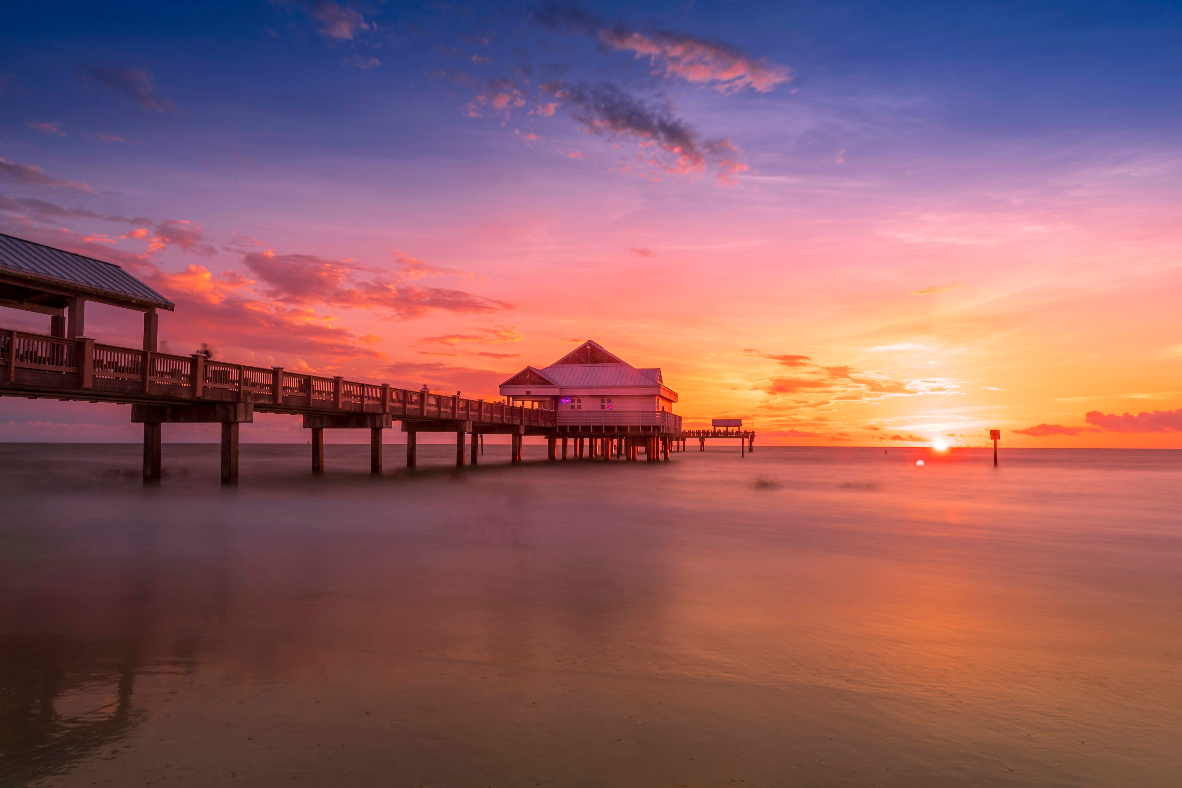 Pier 60 at Clearwater Beach, Florida at sunset with vivid pink and purple sky