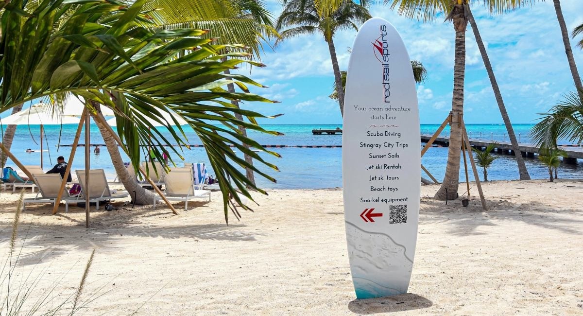 Rum Point beach activities sign listing snorkeling, diving, Stingray City trips, jet ski rentals, beach toys and snorkel equipment available at Grand Cayman North Side