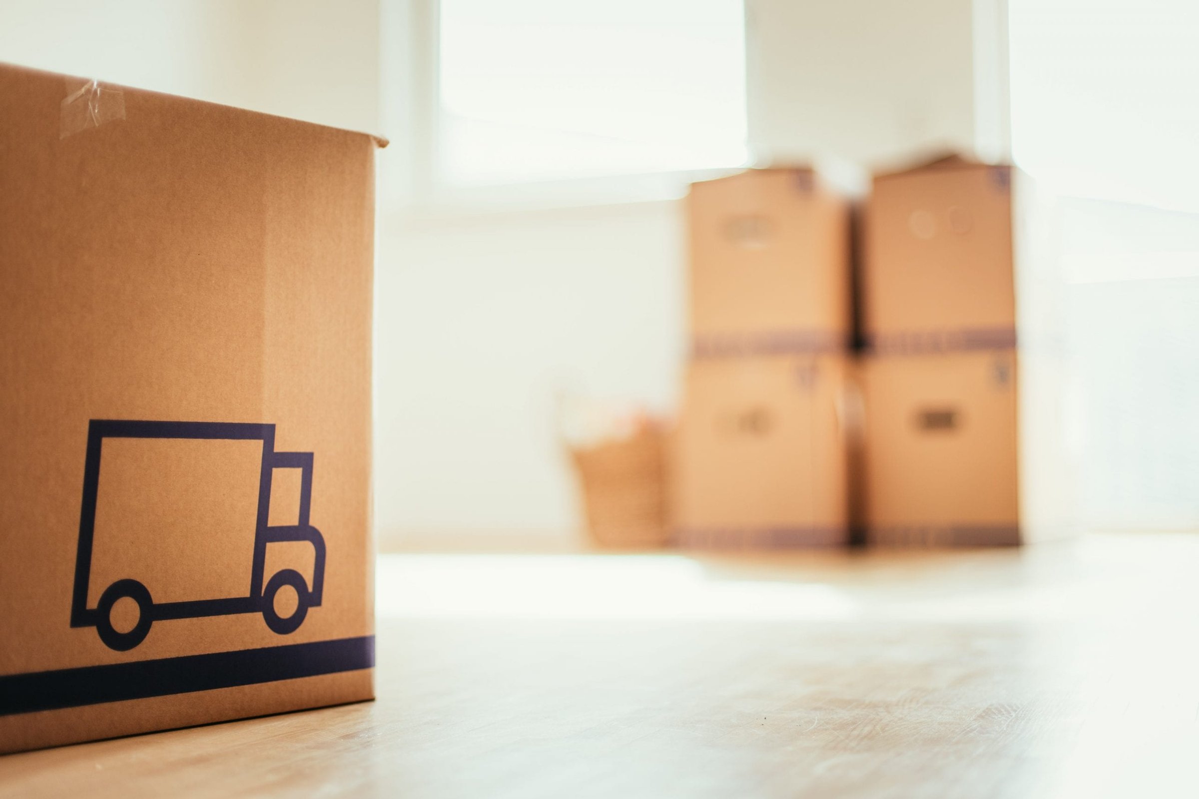 Cardboard box with moving truck pictured on it.