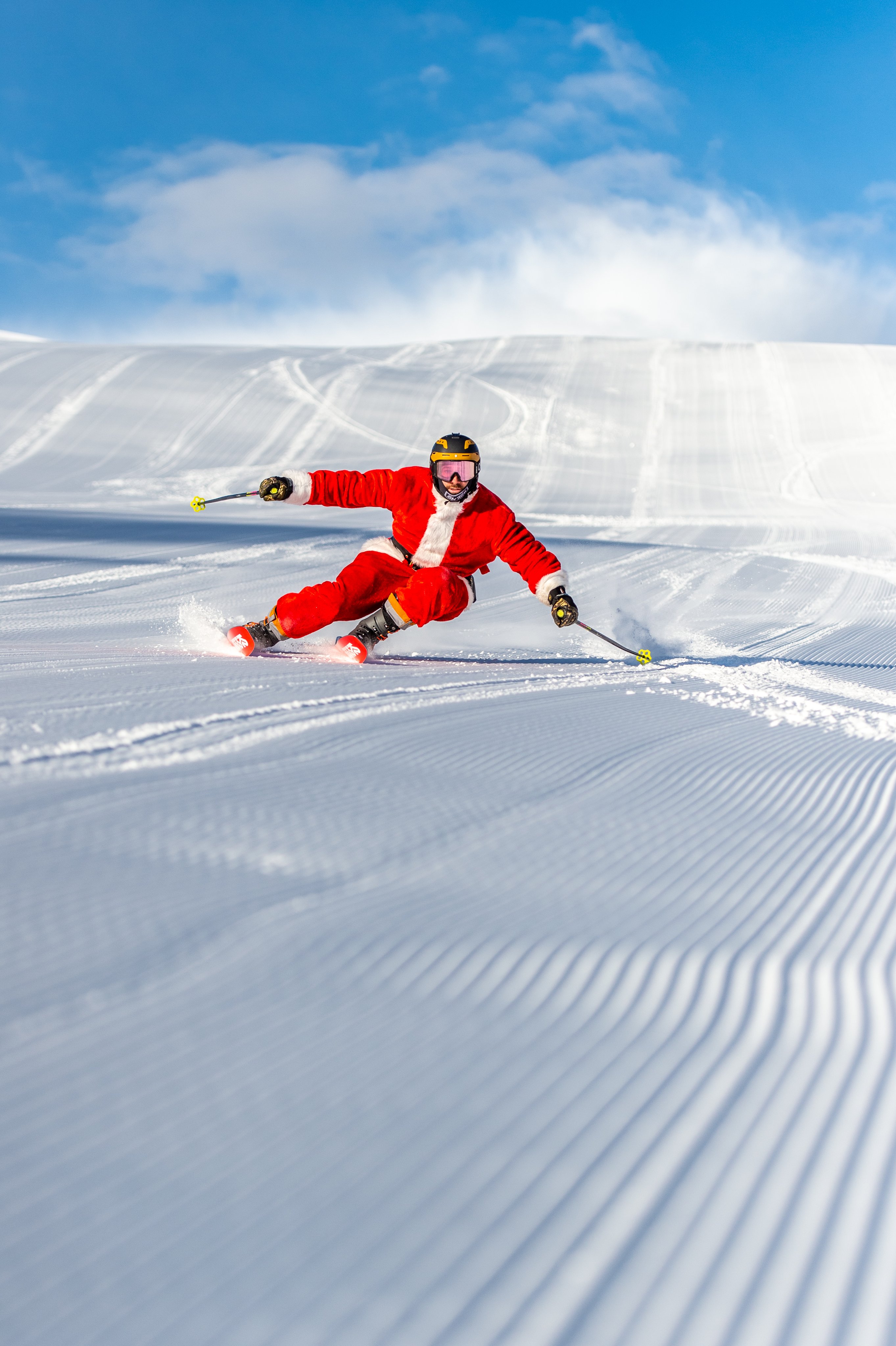 A skier in a santa suit enjoys the fresh groom on Vail Mountain on Dec. 25, 2018. Photo by Whitney Brofos courtesy Vail Resorts.