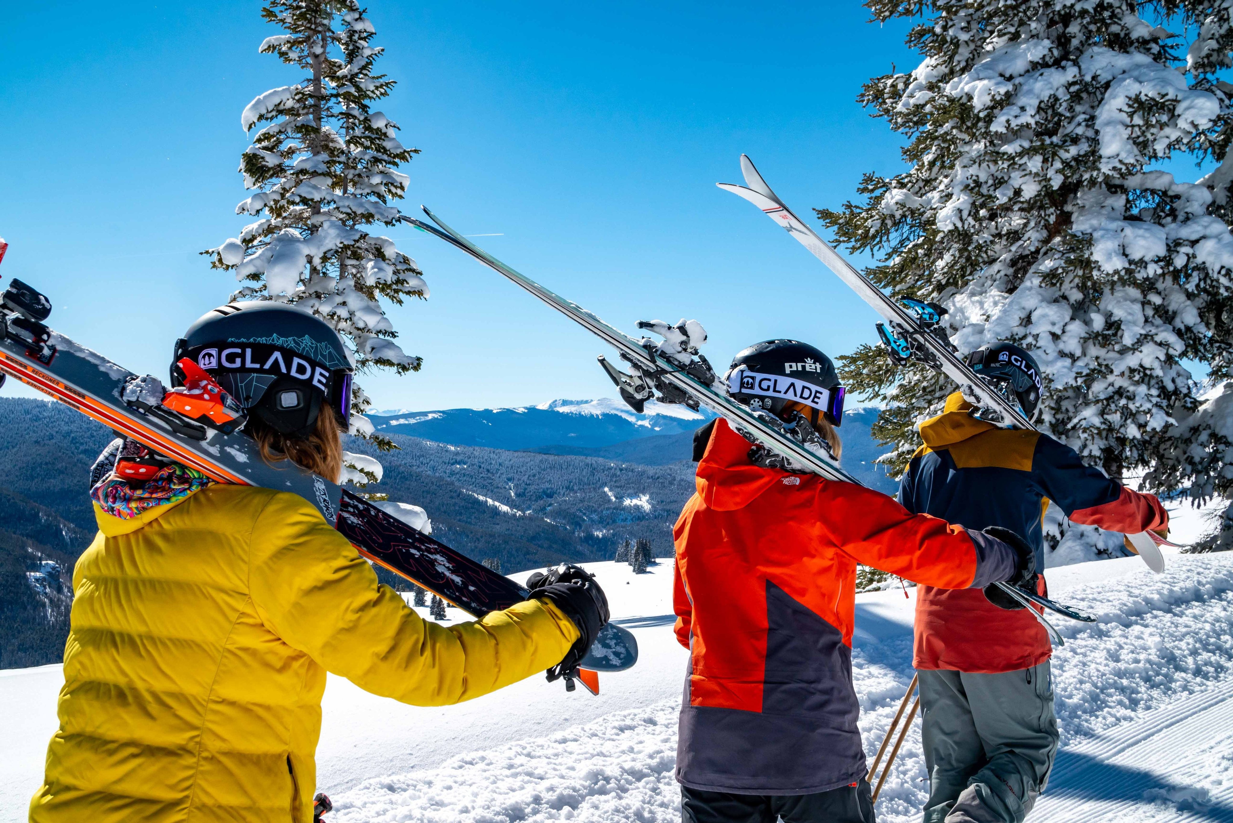 Skiers on a sunny spring slope in Vail