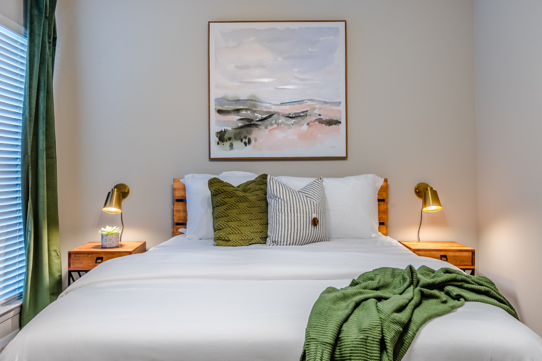 A bright, contemporary bedroom with crisp white linens and natural light, designed for a restful stay.