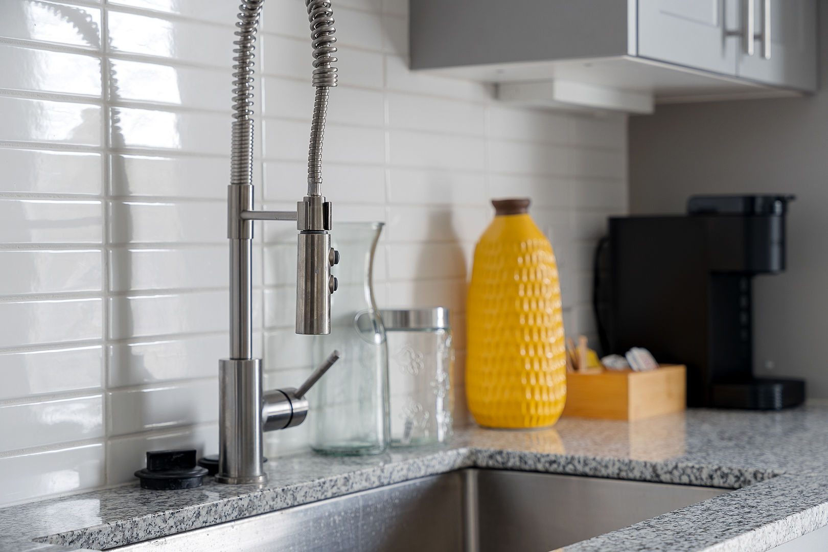 A modern kitchen featuring a gourmet coffee maker and stainless steel appliances