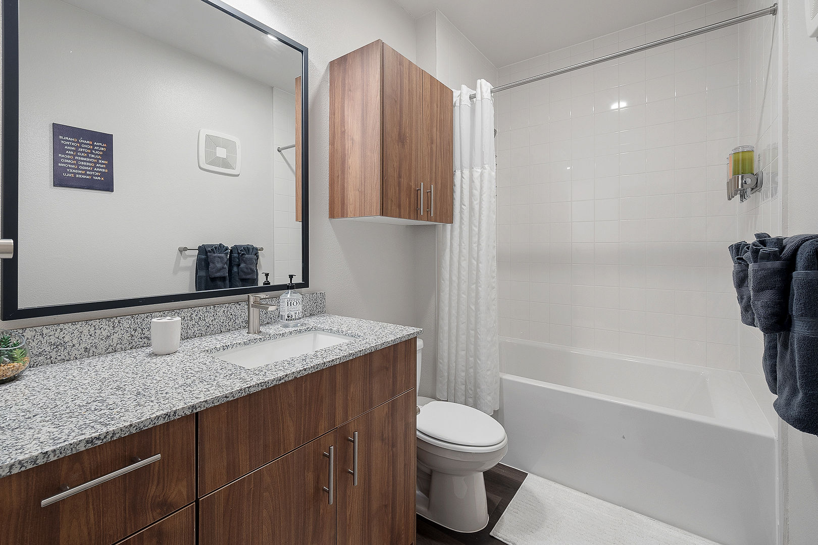 A modern, clean bathroom at PBD Living, stocked with premium towels and cleaned with sustainable products.