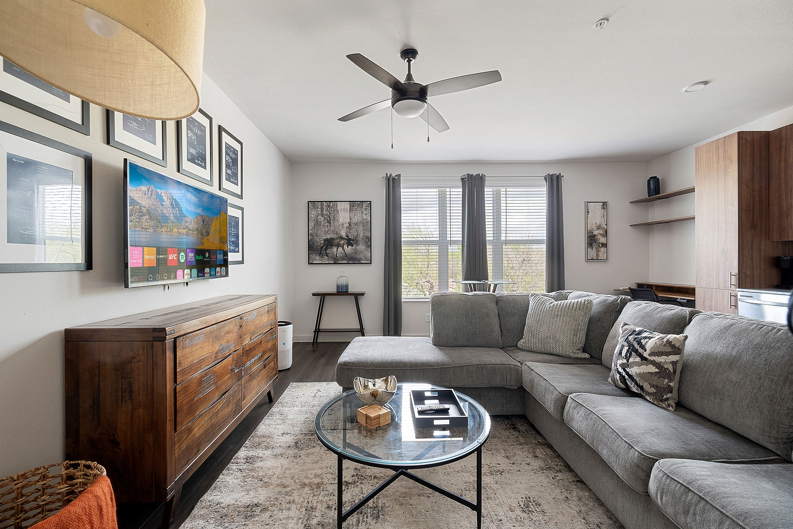 Spacious living area with a large sectional sofa and smart TV