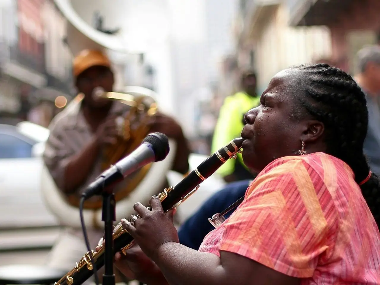 Woman clarinet player with tubist playing jazz music on a French Quarter street.