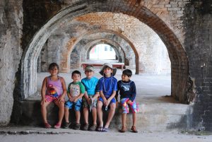 Group of young children gathered at Fort Pickens in an old brick structure