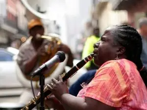 Woman clarinet player with tubist playing jazz music on a French Quarter street.