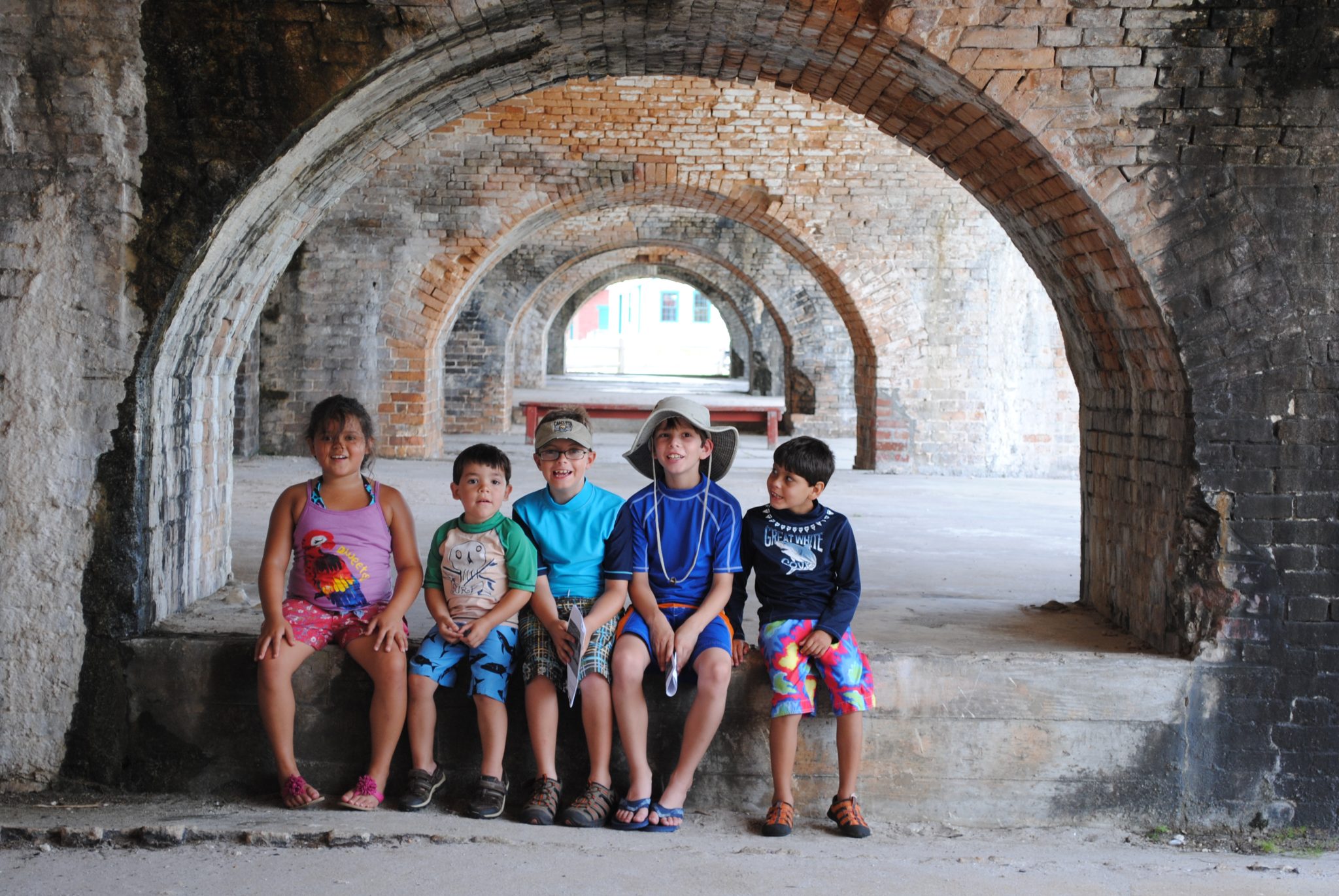 Group of young children gathered at Fort Pickens in an old brick structure