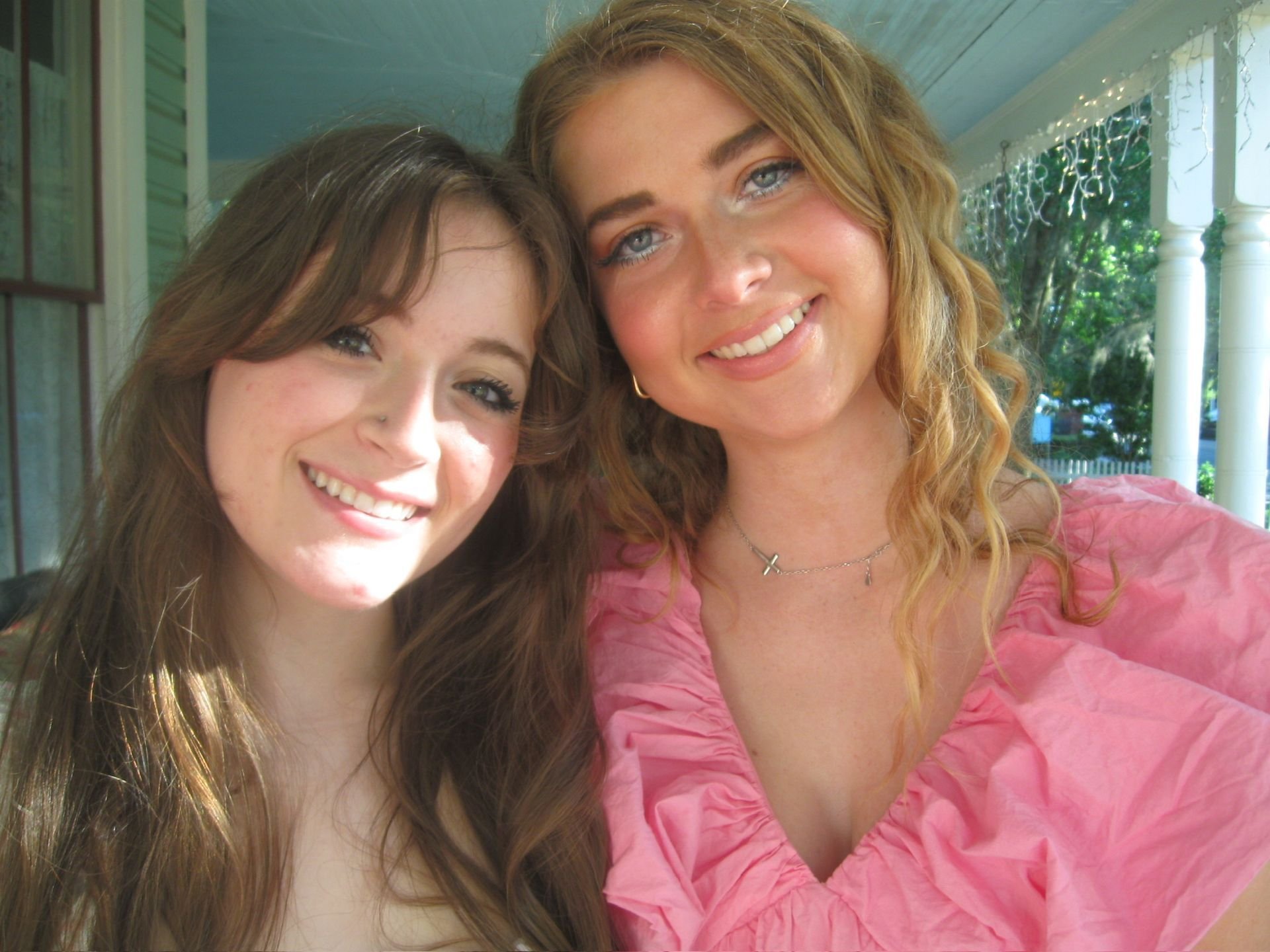 women smiling while outside of the camellia rose inn