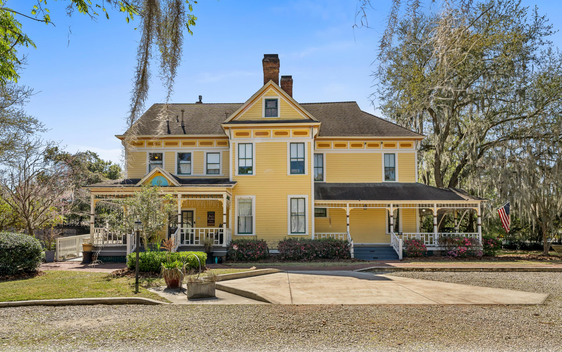 The exterior of the Laurel Oak Estate - featuring 2 covered outdoor porches and parking for 8 cars