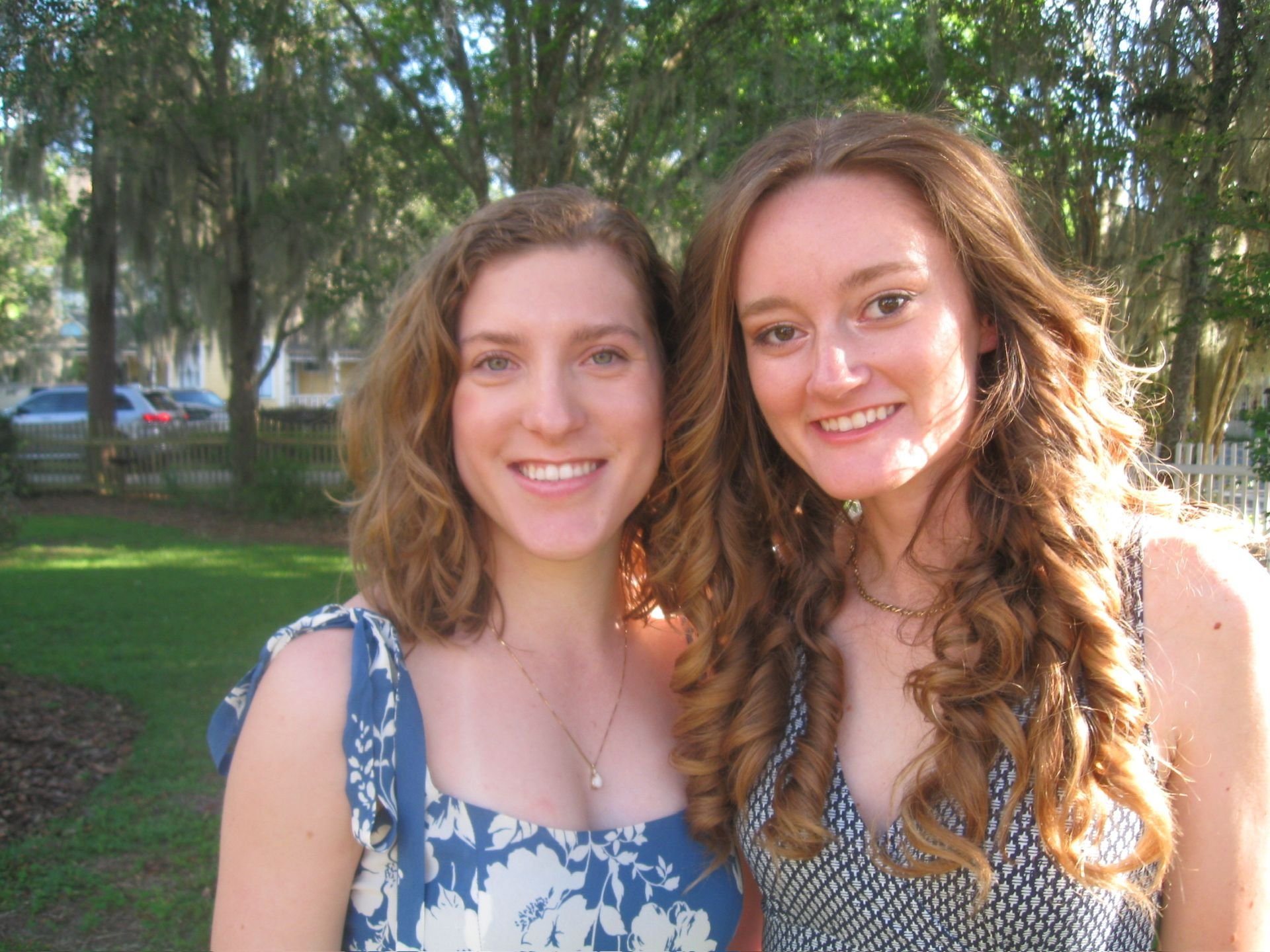 women smiling outside of the camellia rose inn