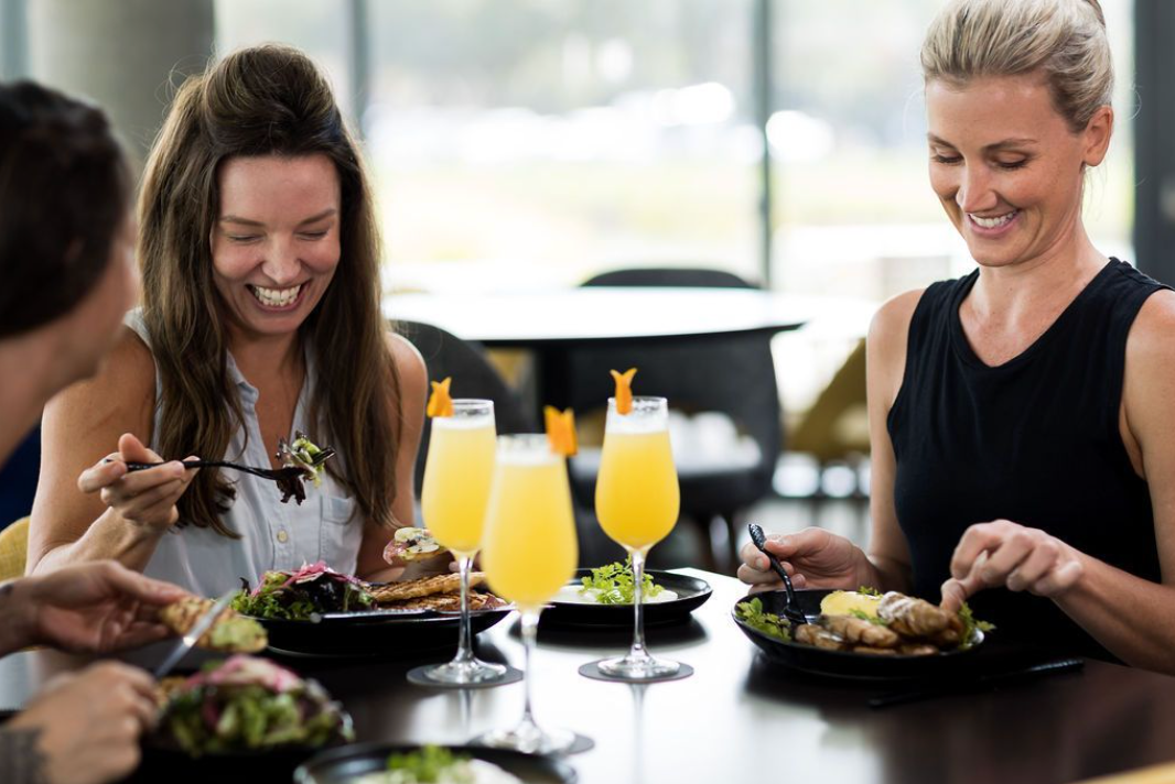 Two women enjoying brunch and mimosas at The Laurel Oak Inn.