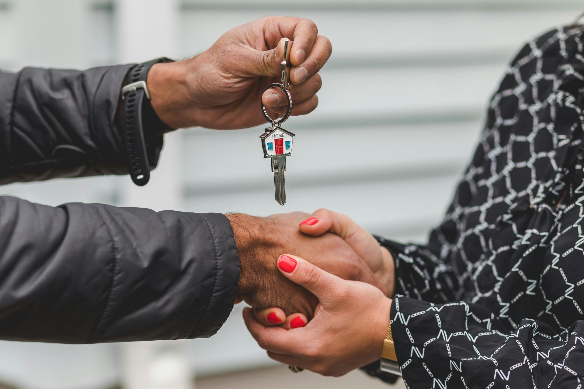 Happy AirBNB property owners handing over the key to StayGainesville