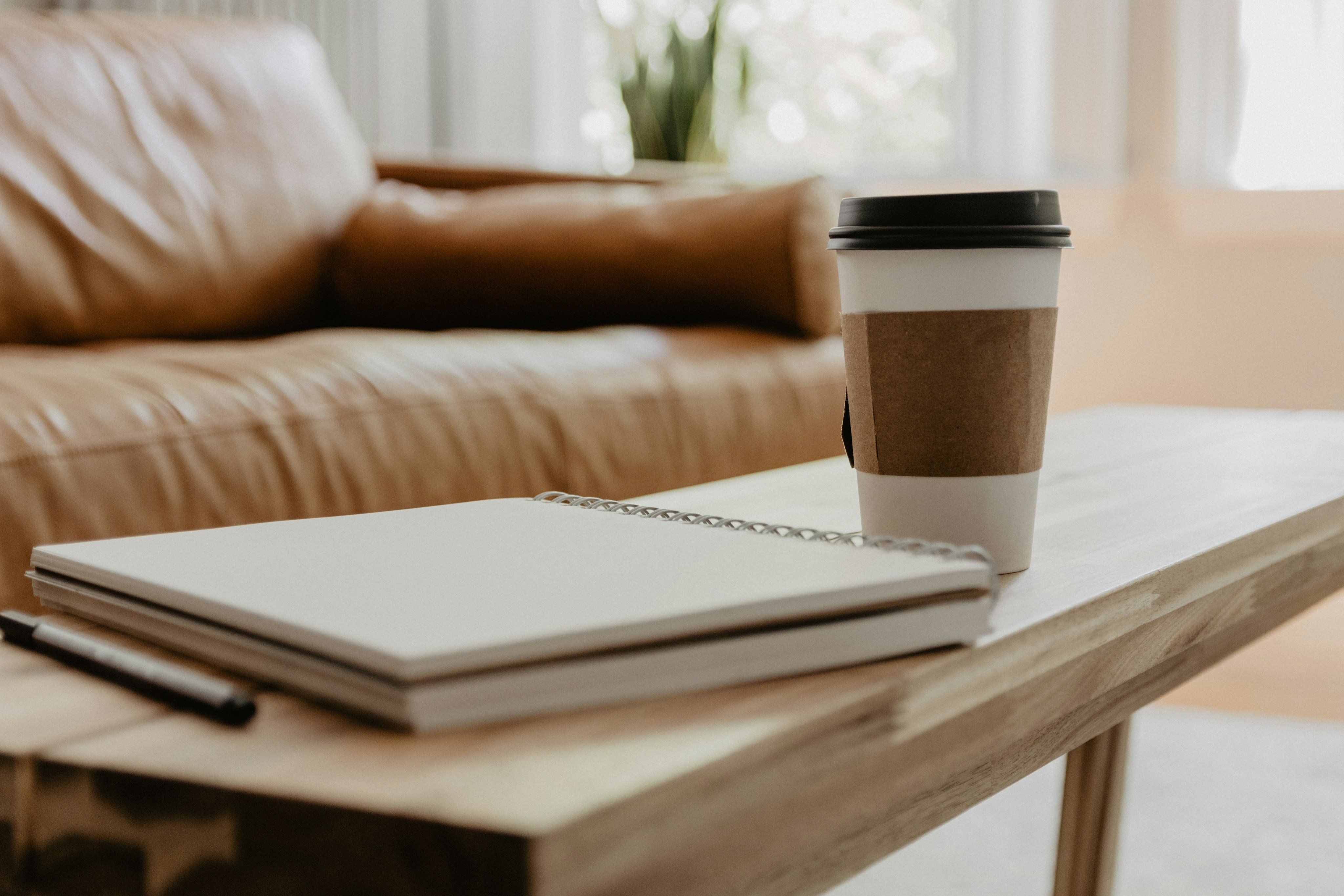 Notebook and coffee on a cabin bench — planning your Broken Bow cabin rental budget