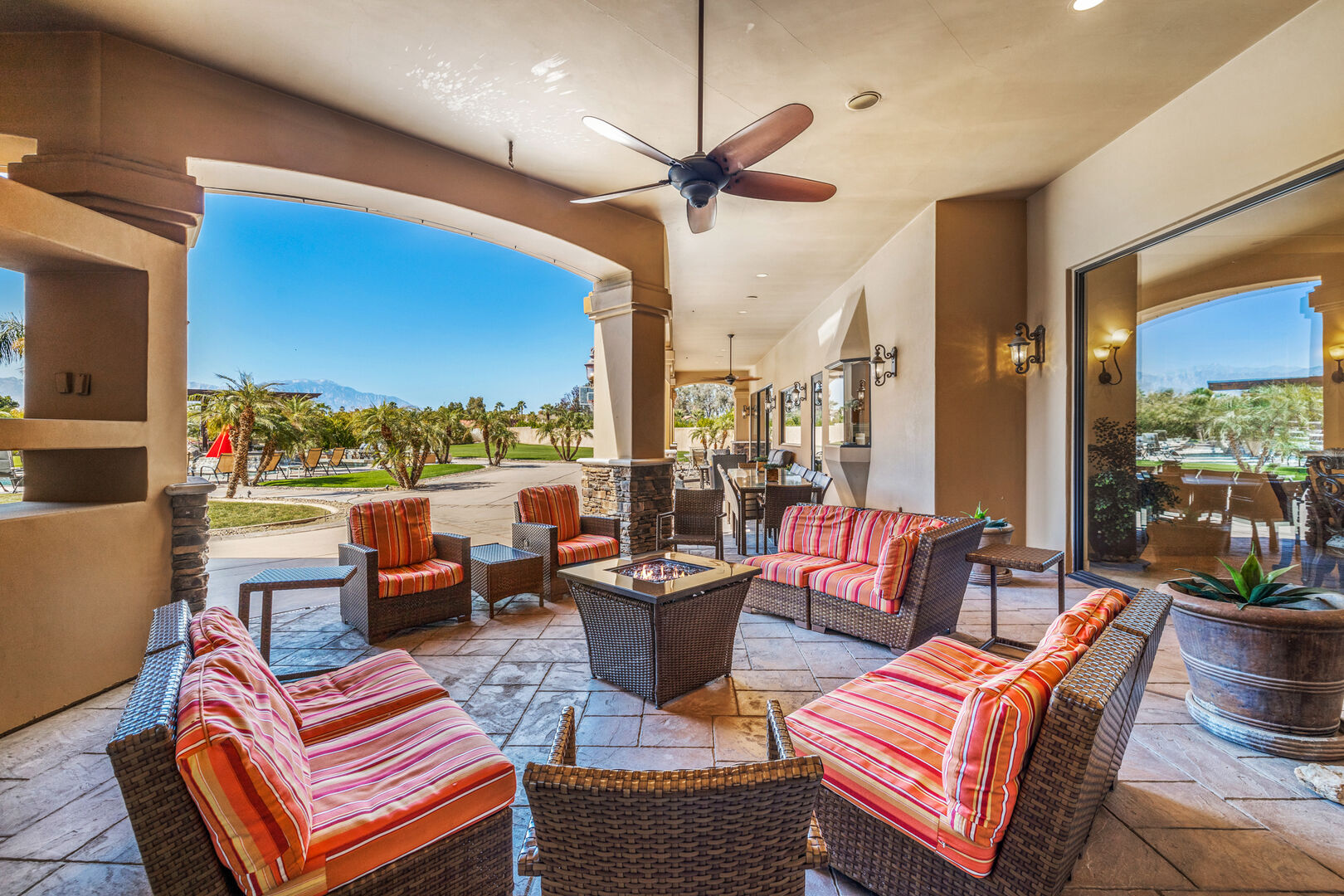 A group gathered around the long outdoor dining table at Yucca Dunes