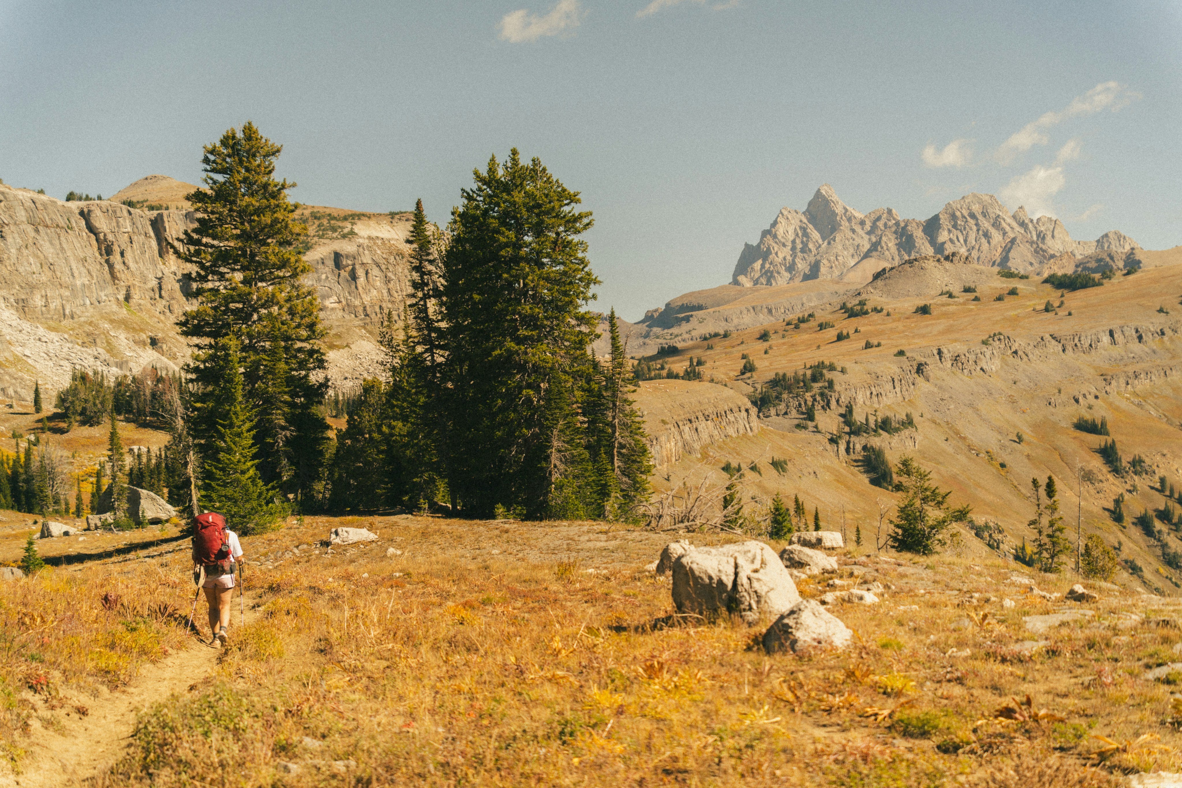 Hiker on autumn trail in the Tetons, Wyoming