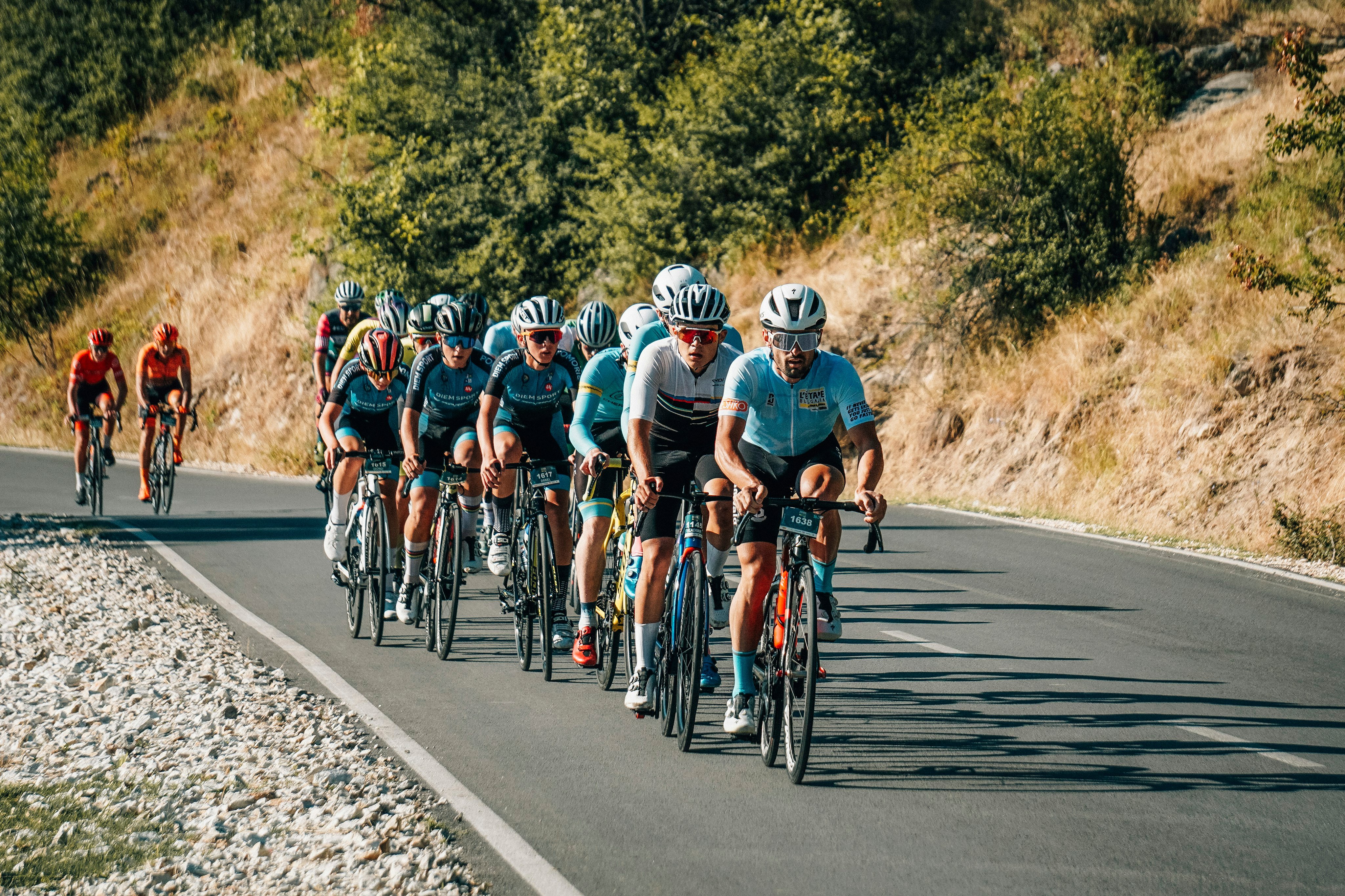 Peloton of cyclists climbing a mountain road, Dead Swede Gravel Race