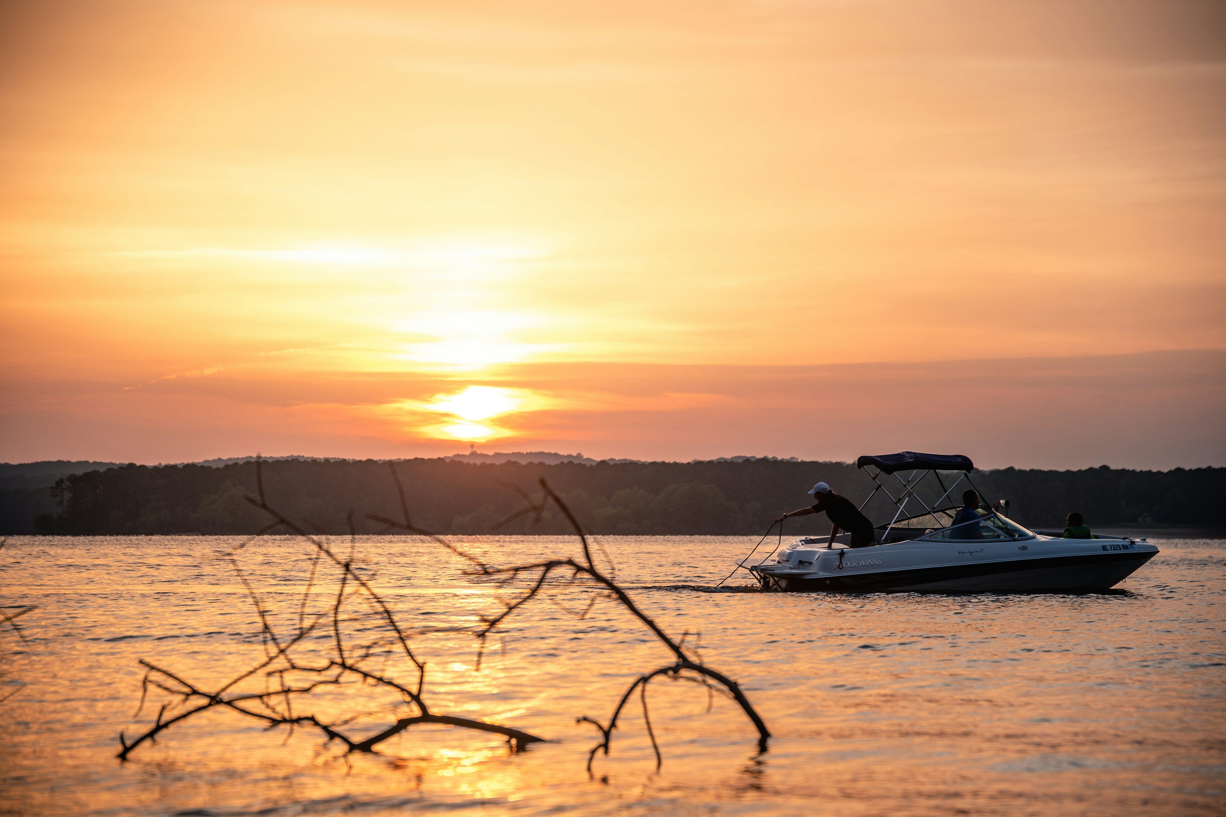 Motorboat on Broken Bow Lake at golden sunset