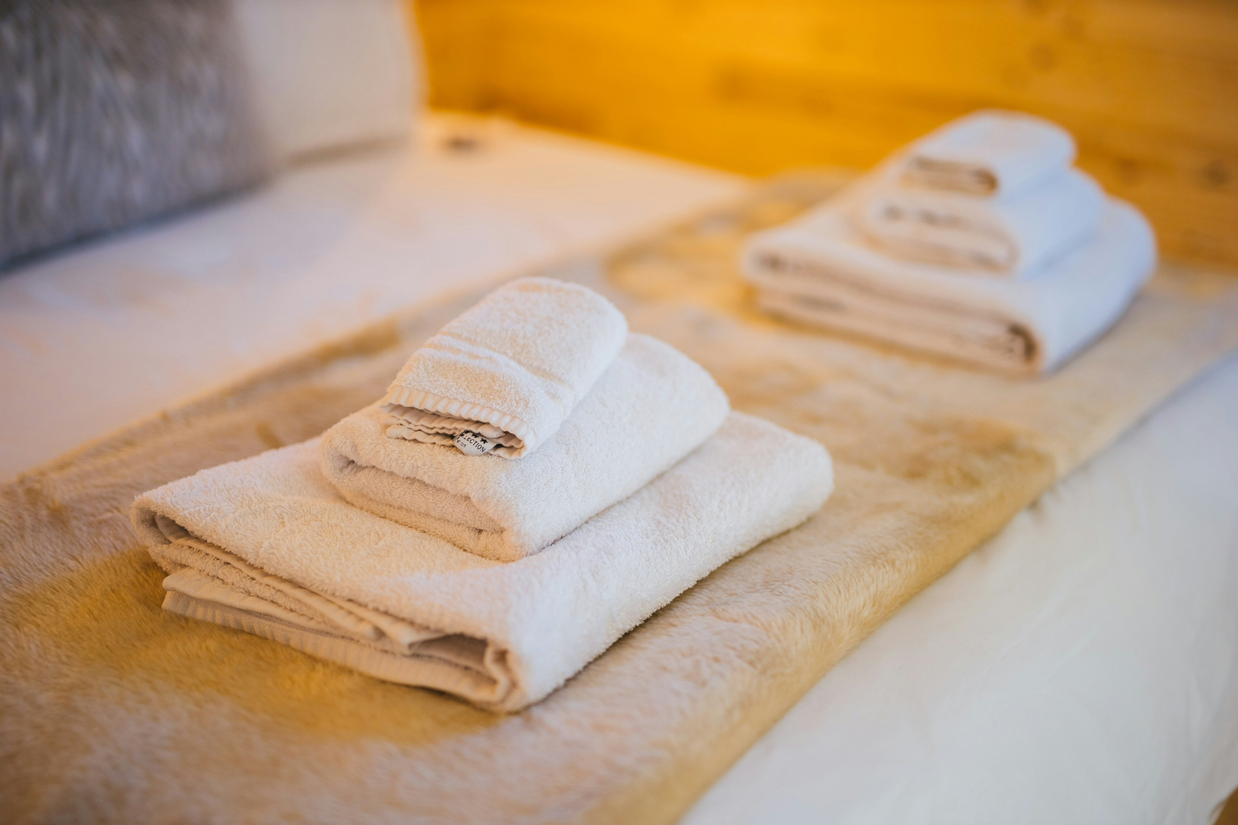 Fresh folded towels on bed