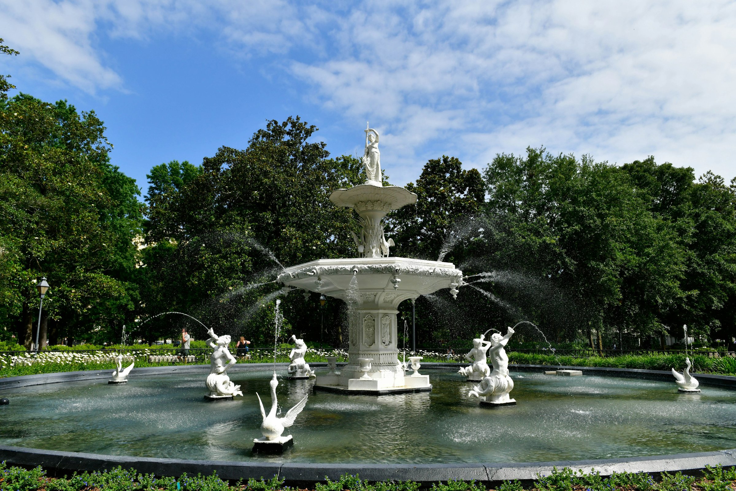 The fountain at Forsyth Park in Savannah framed by live oaks on a bright morning