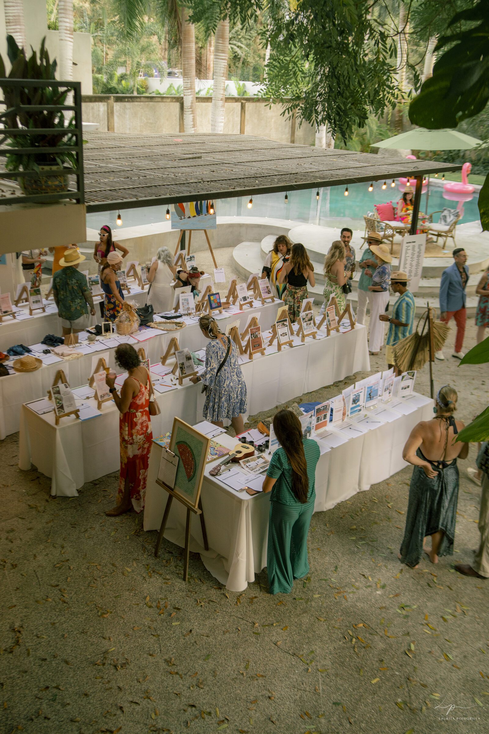 Silent auction tables by the pool at Acapulco Nights