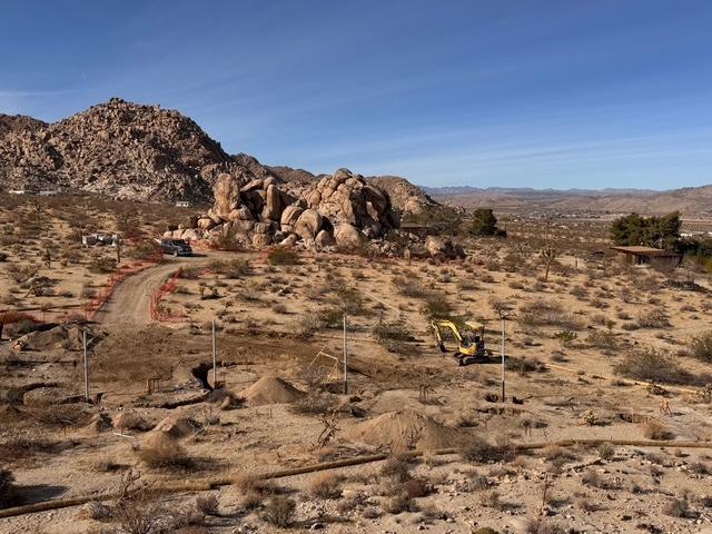 Aerial view of the Cloud Rock site with boulder outcrop and excavator