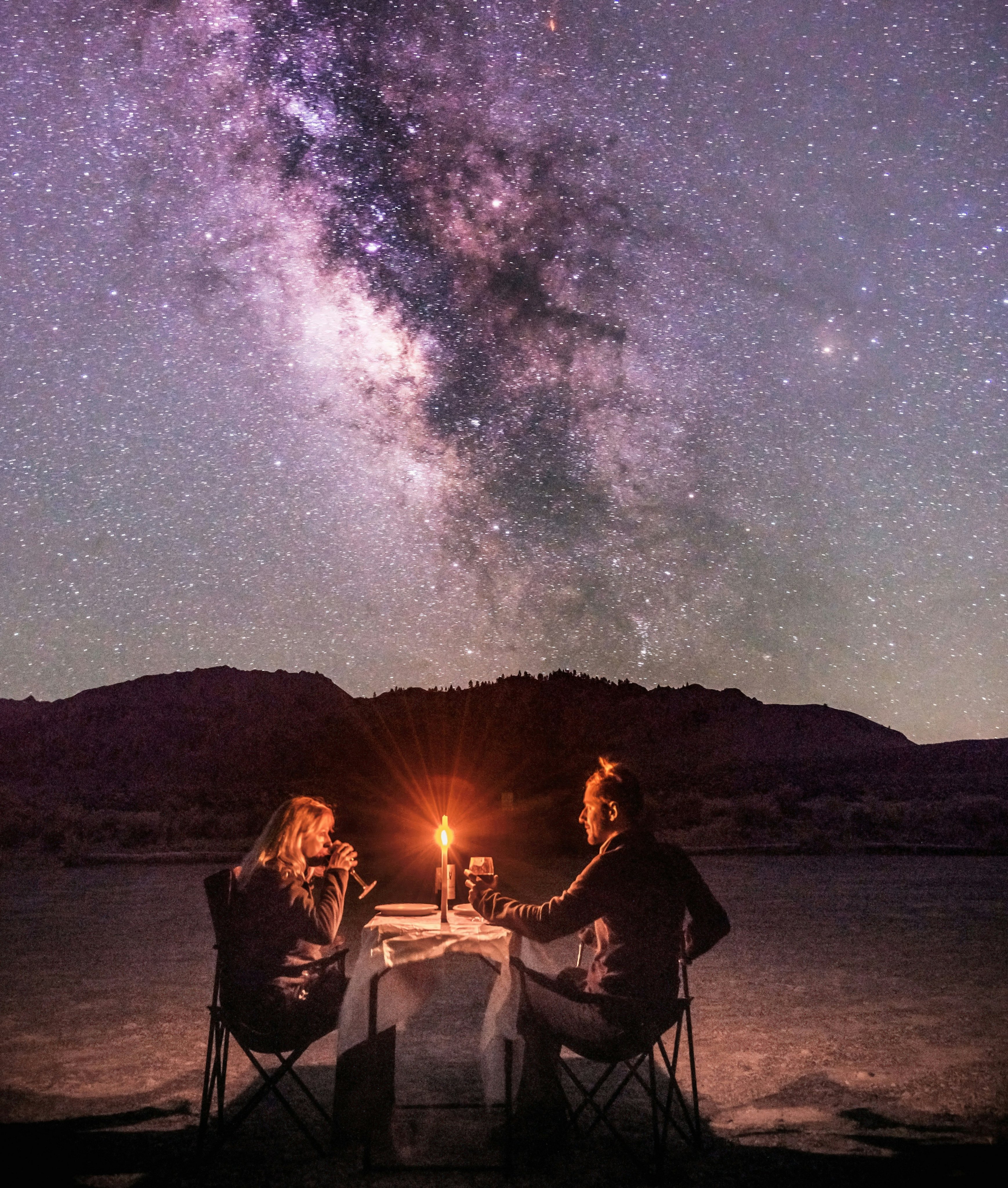 Candlelit dinner under the desert night sky