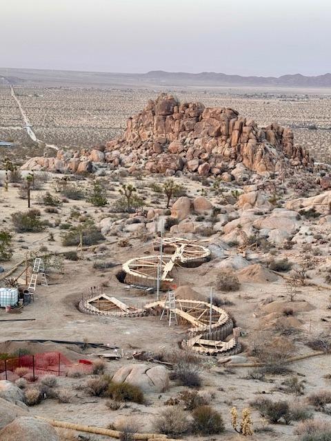 Aerial overview of all three circular forms against the Joshua Tree desert