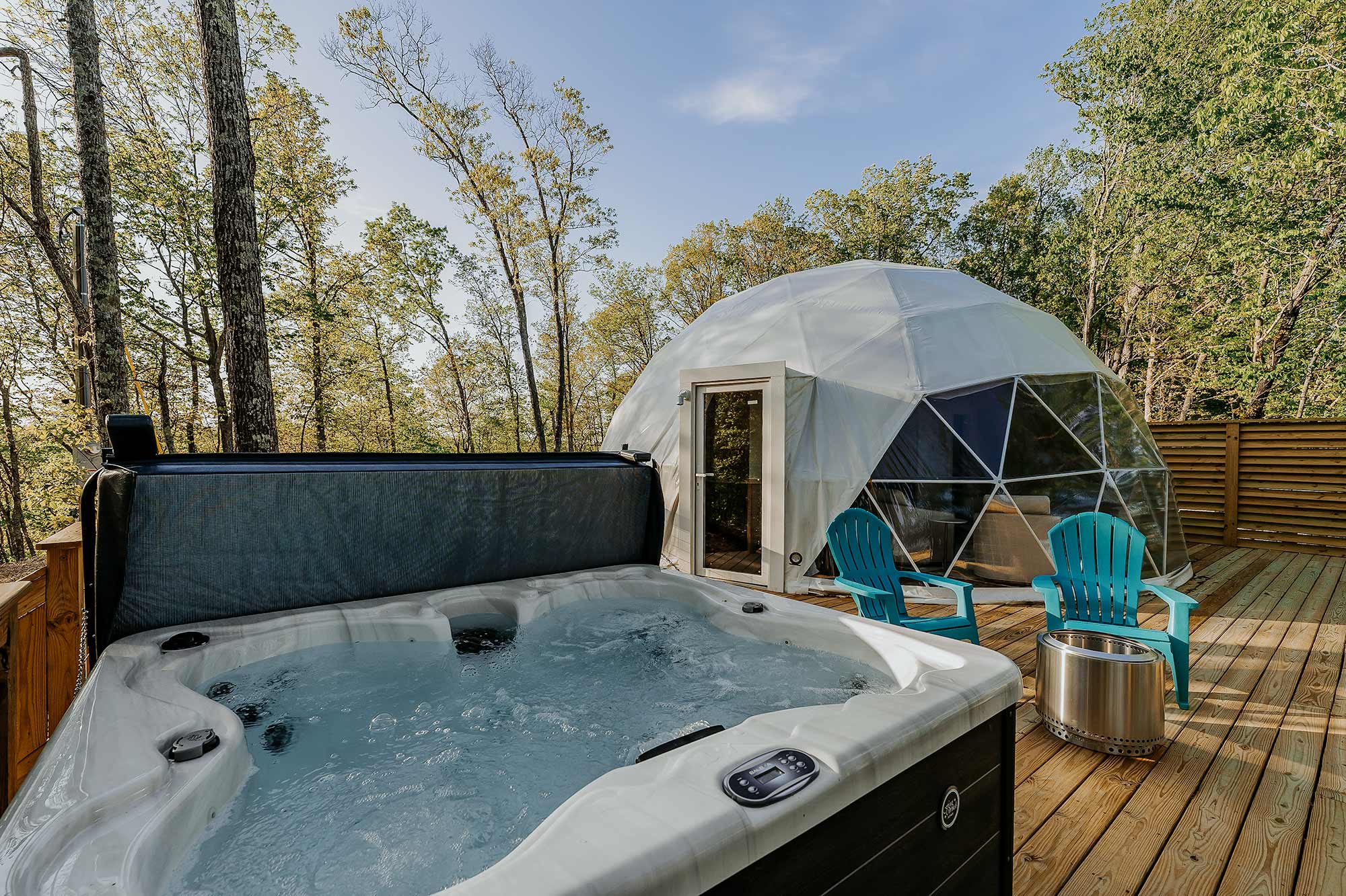 Outdoor hot tub and geodesic glamping dome on a private deck overlooking the woods at Center Hill Lake, perfect for relaxing after a day of fishing.