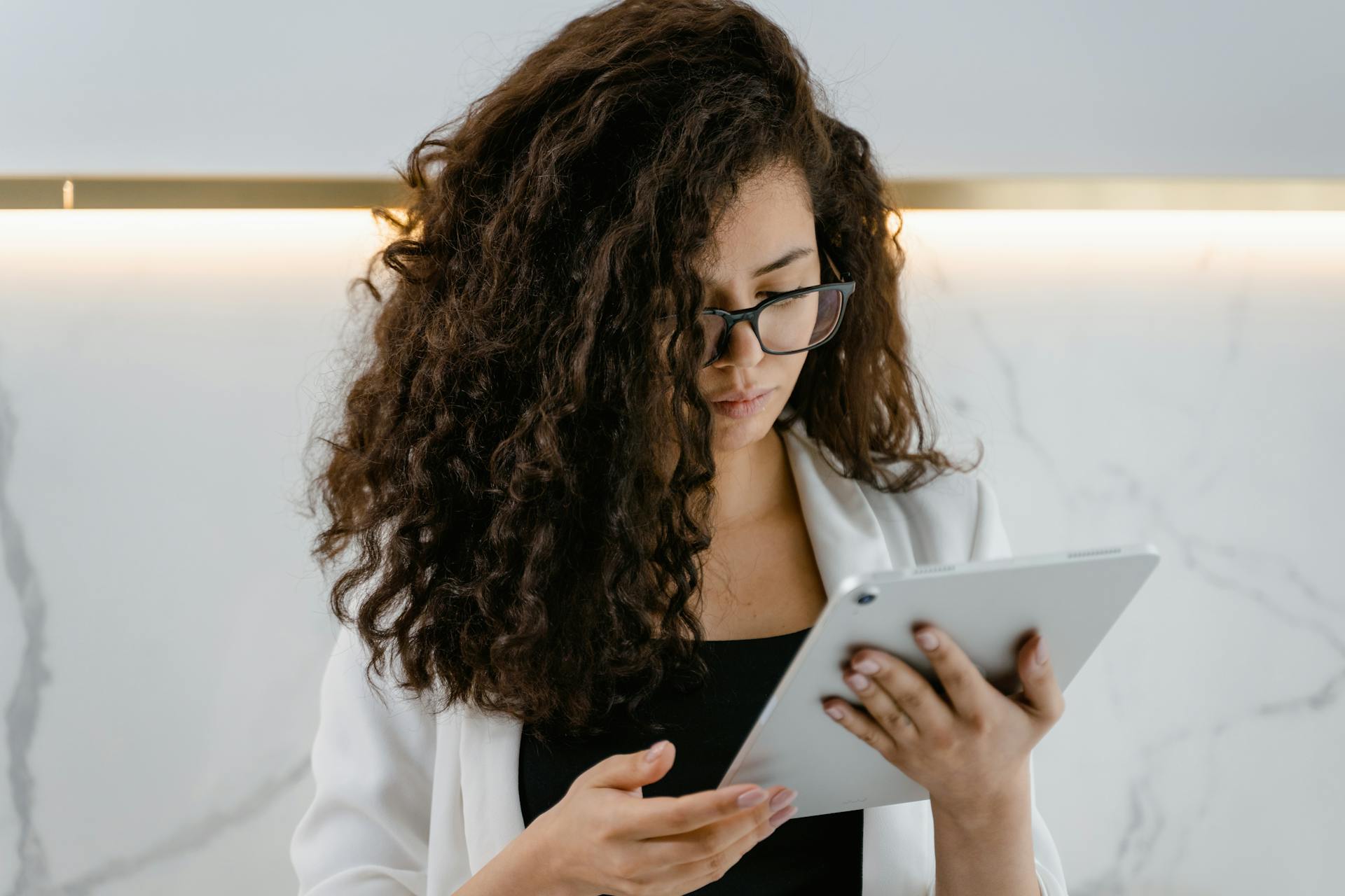 A woman scrolling on a tablet