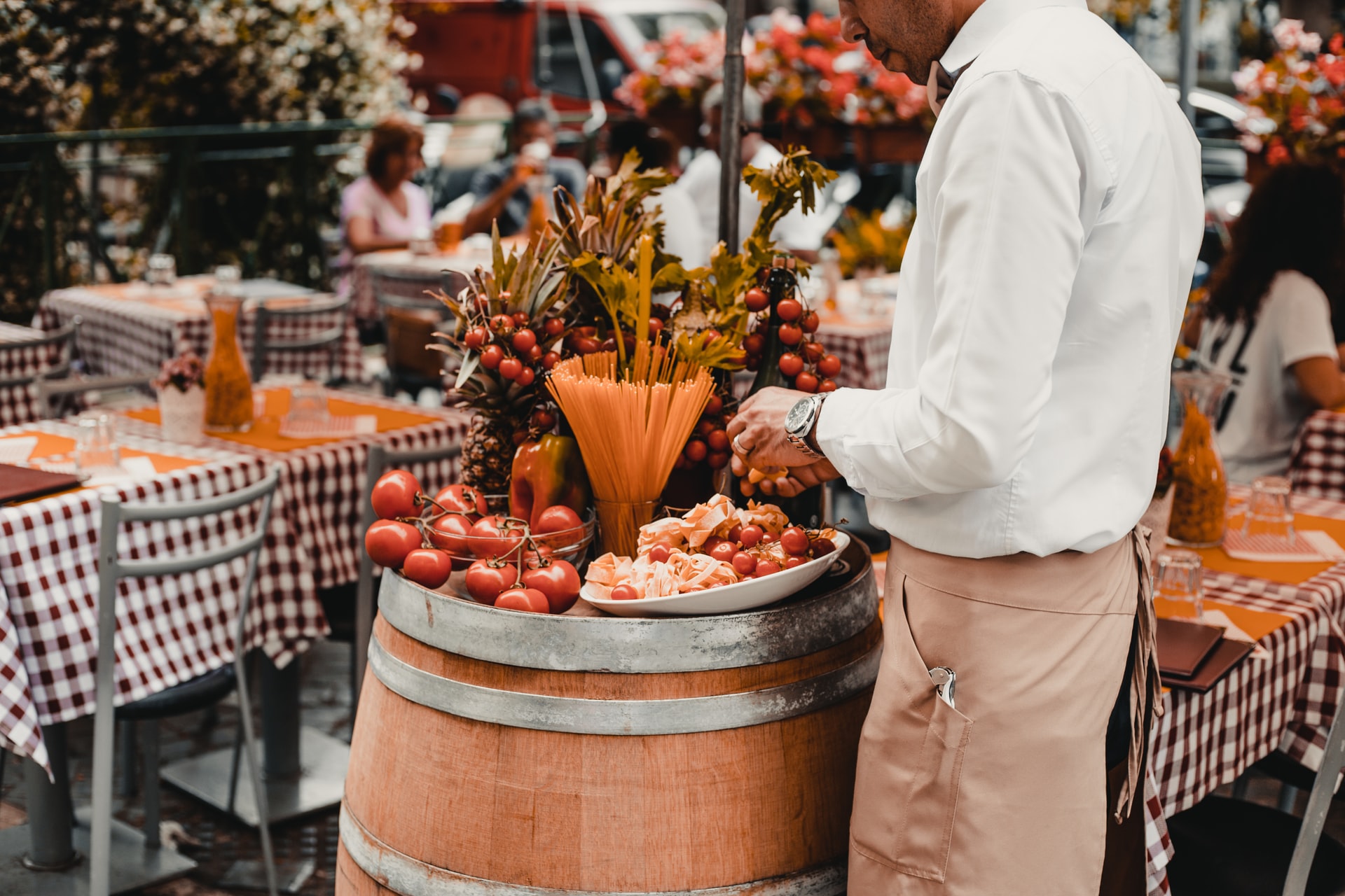 man standing by a barrel with pasta