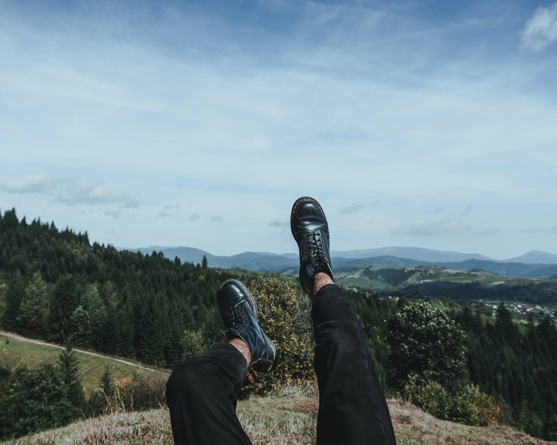 person with their feet in the air on a mountain