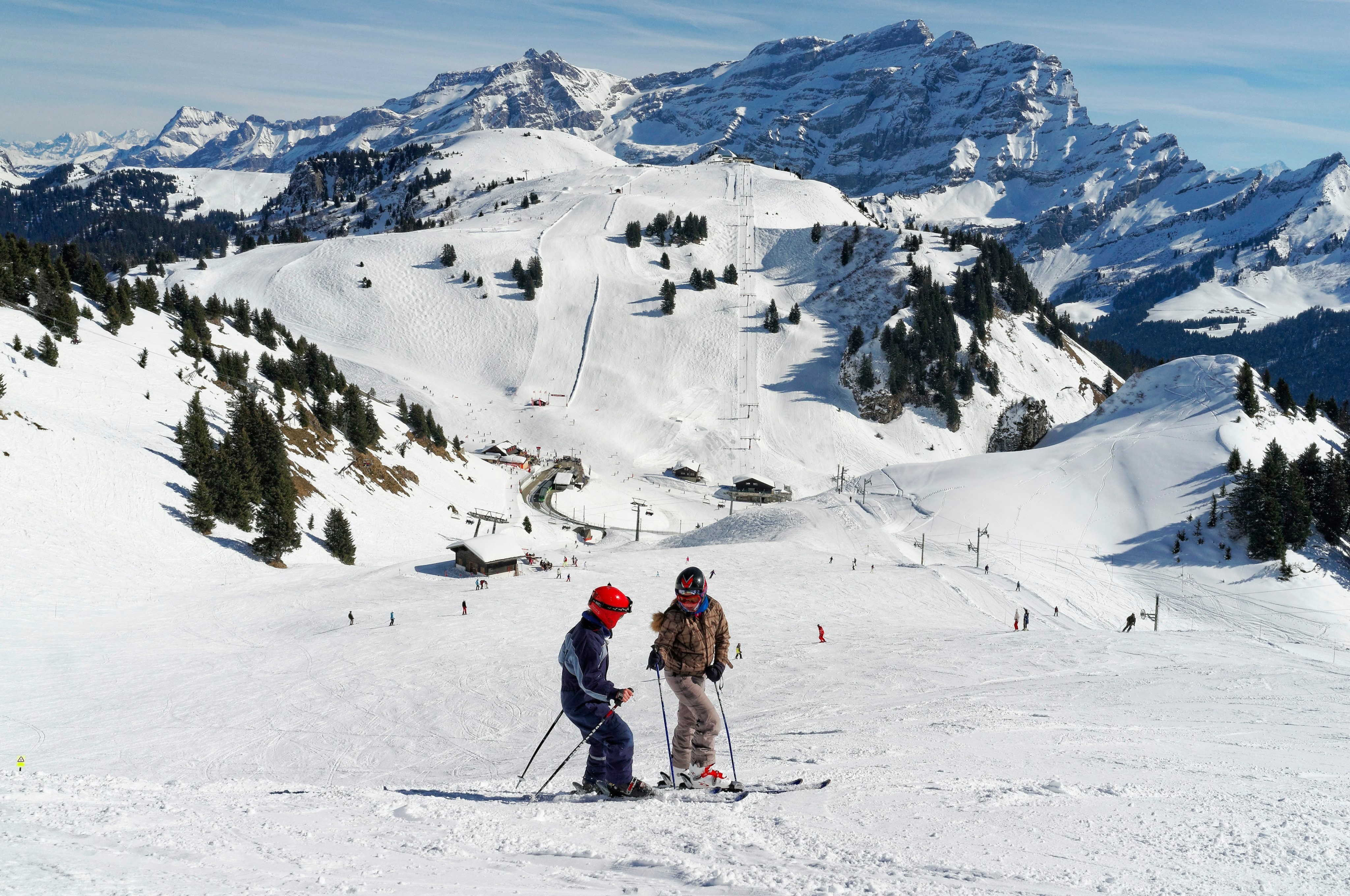 Two skiers on a sunny alpine slope