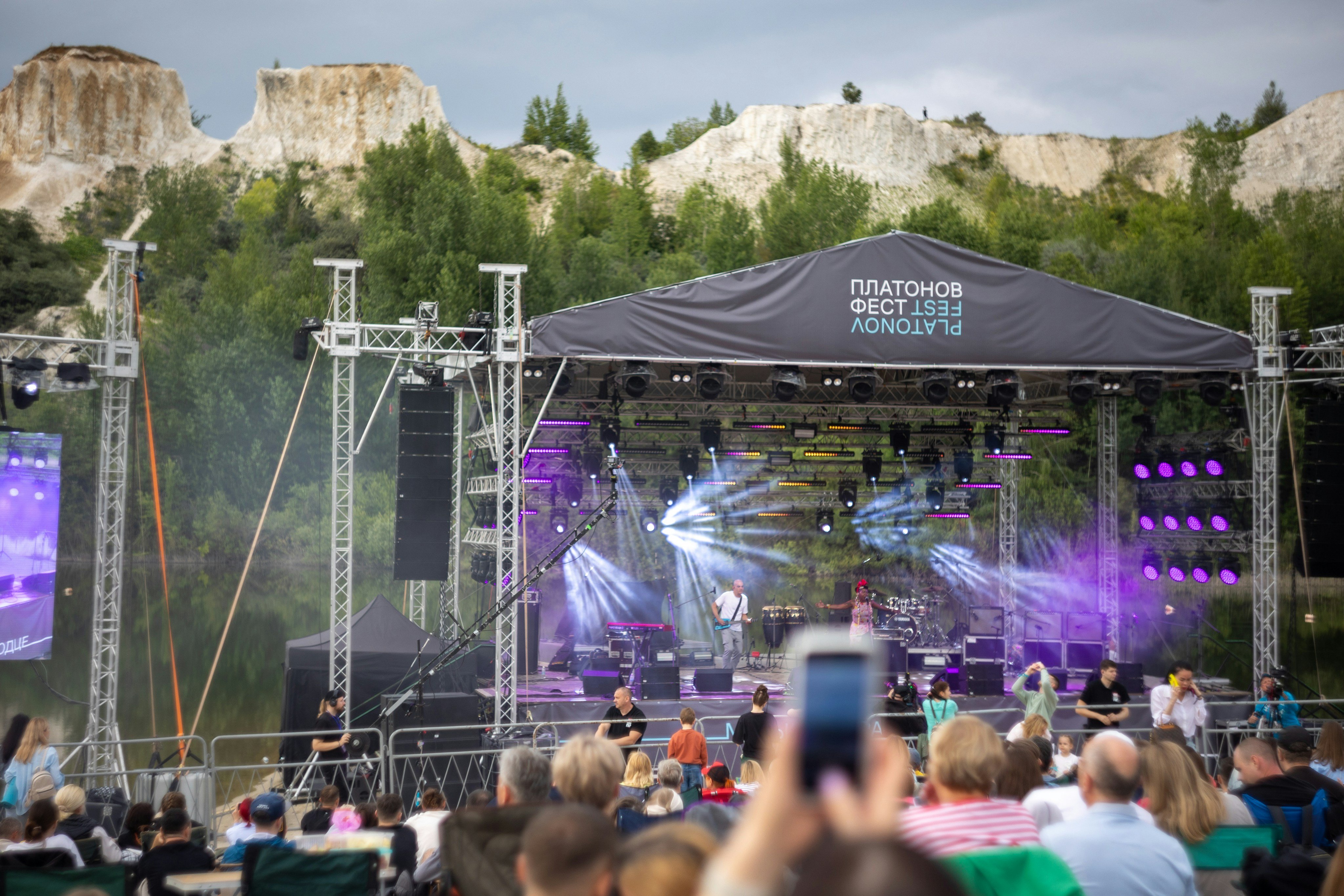 Outdoor concert stage with rocky mountain backdrop