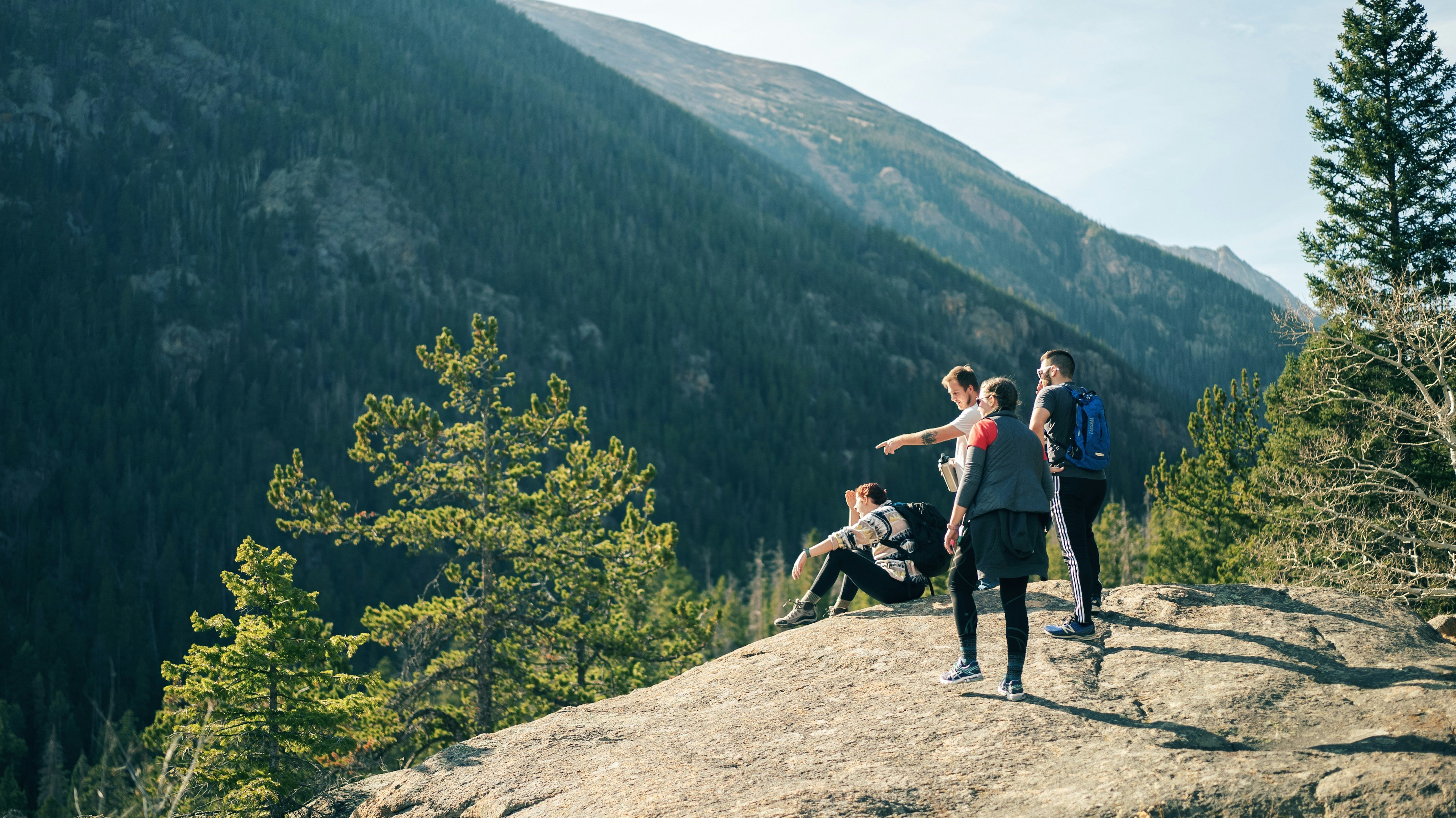 Group of hikers on a rocky outcrop in the Canadian Rockies