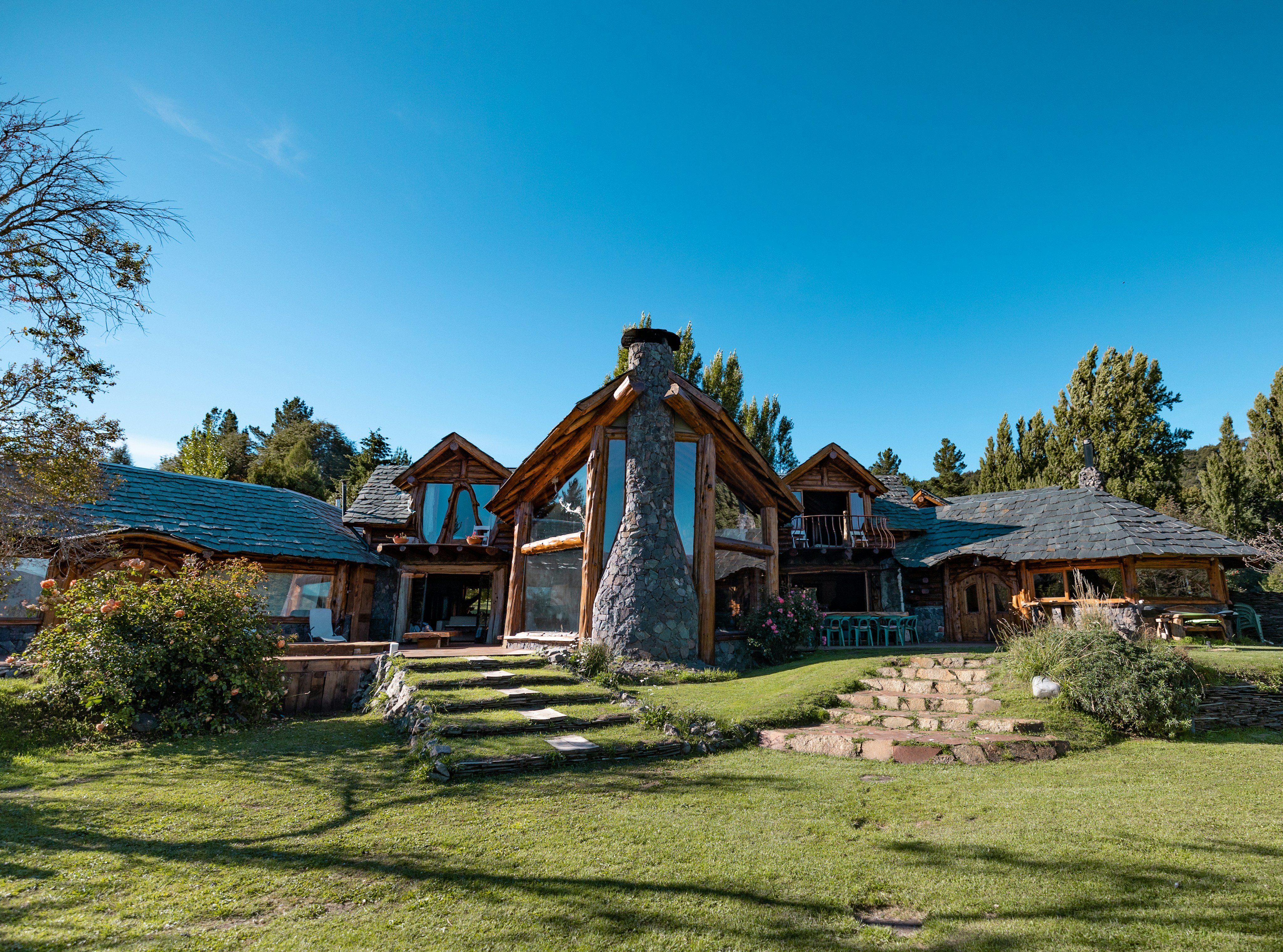 Large timber-frame lodge exterior with mountain views