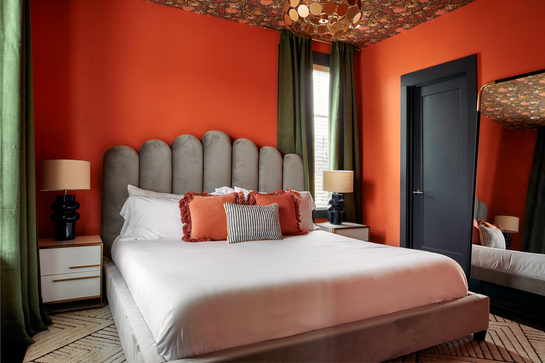 Maximalist primary bedroom with bold patterns and layered textiles