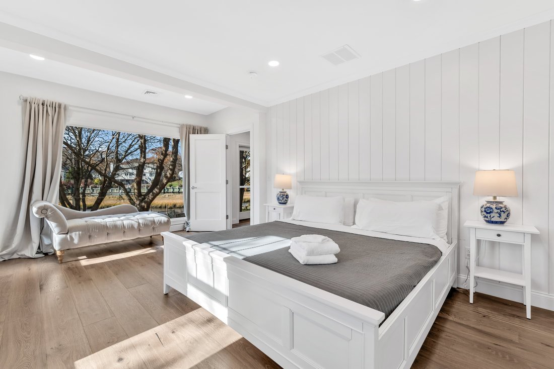 The Madeline primary suite with floor-to-ceiling water views