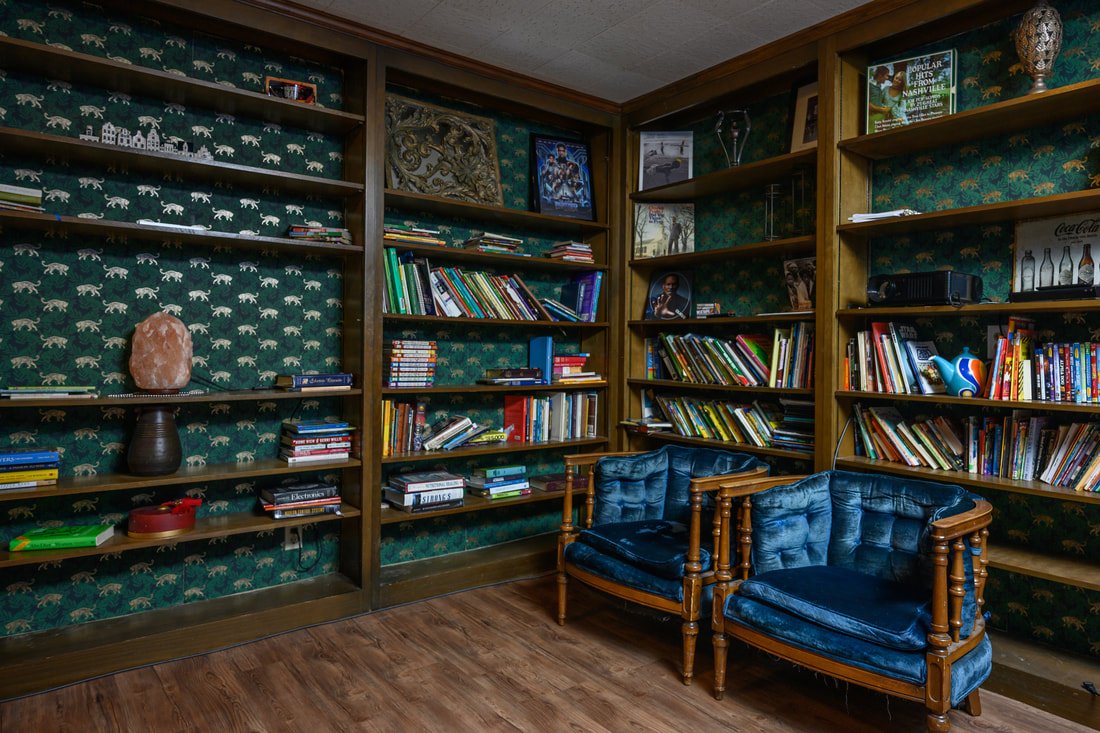 Library and projector movie theater room at Nashville midcentury modern home
