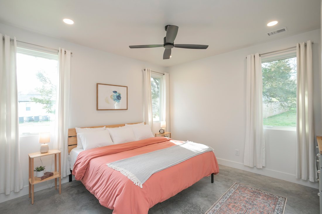 Primary bedroom with king bed and floating vanity