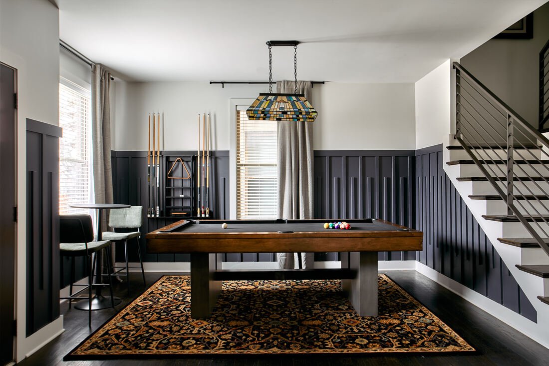 Modern game room with sleek furniture and feature lighting