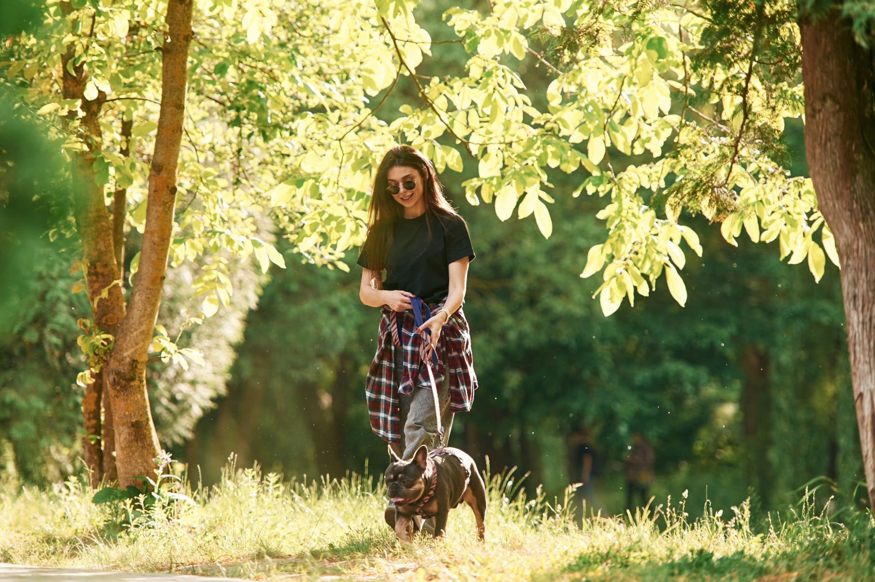 woman walking dog at park